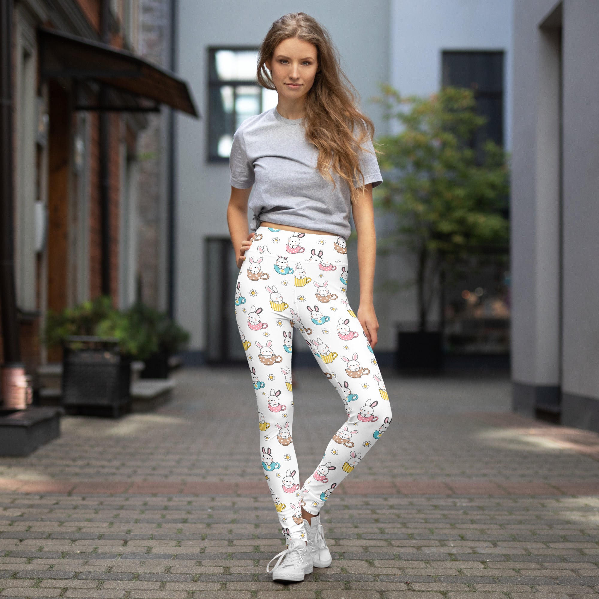 White buttery soft high waisted yoga leggings with pastel cartoon bunnies holding teacups and snacks for women