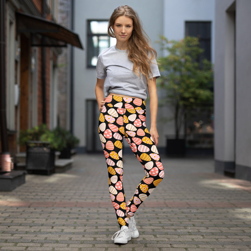 Women’s coral easter egg buttery soft black leggings with pastel pink yellow and peach patterned eggs for yoga comfort