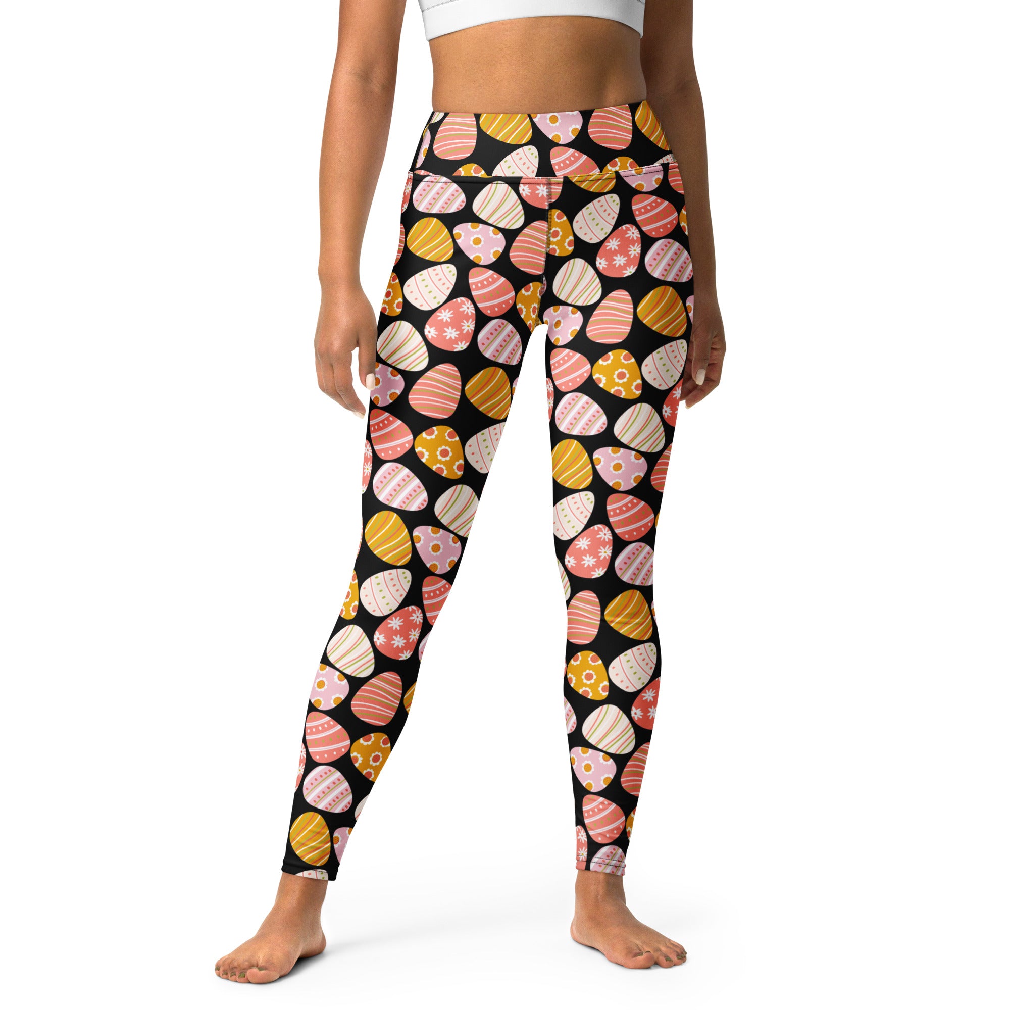 Women’s black high waisted buttery soft yoga leggings with pastel pink yellow and white easter egg pattern
