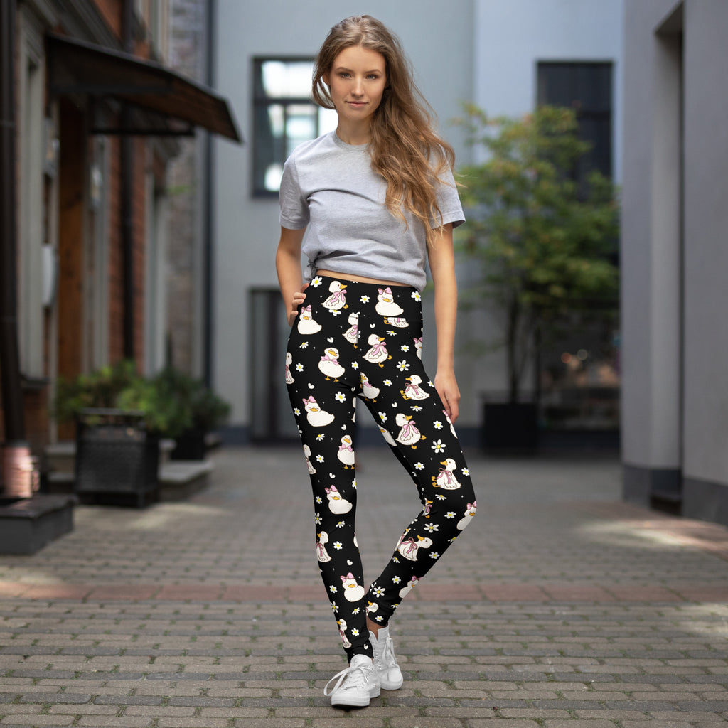 Black women’s cute duck buttery soft yoga leggings with white and pink cartoon ducks and floral accents for quick drying