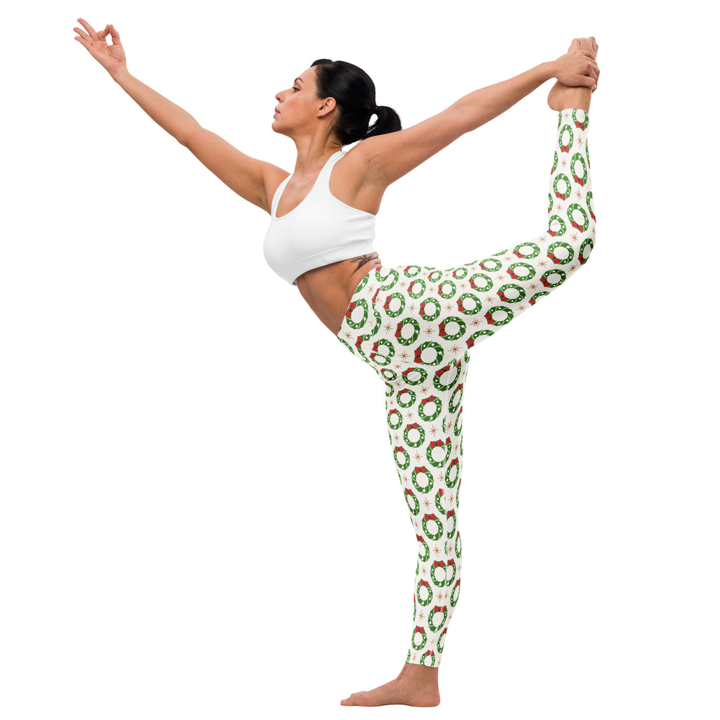 White buttery soft women’s yoga leggings with festive green wreaths red bows and small white stars pattern