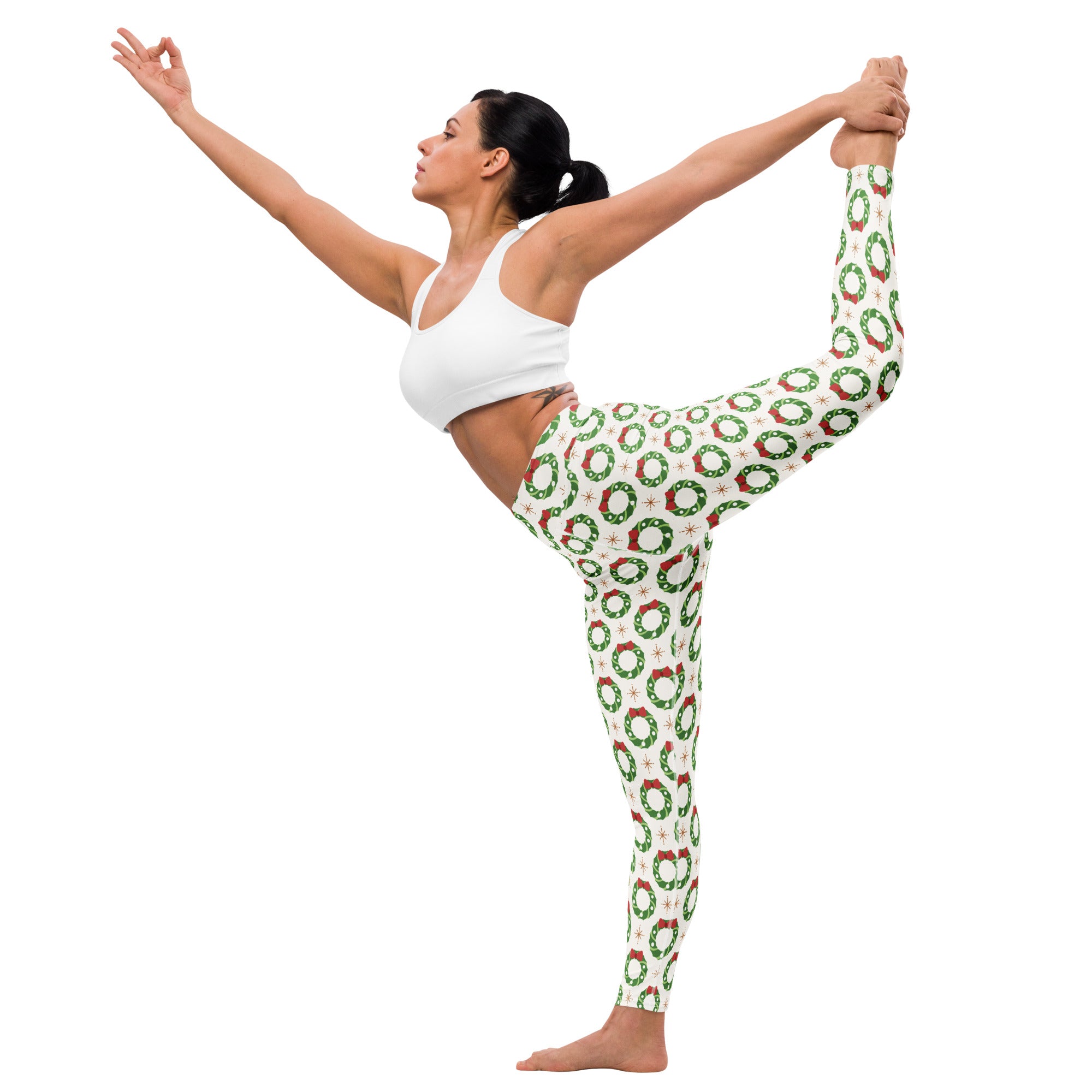 White buttery soft women’s yoga leggings with festive green wreaths red bows and small white stars pattern