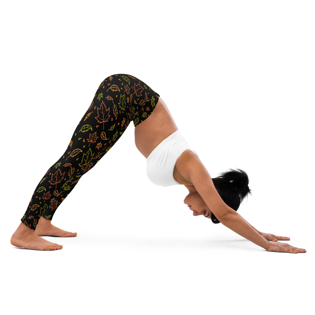 Black buttery soft yoga leggings for women with vibrant outlined neon green orange and yellow maple leaves pattern