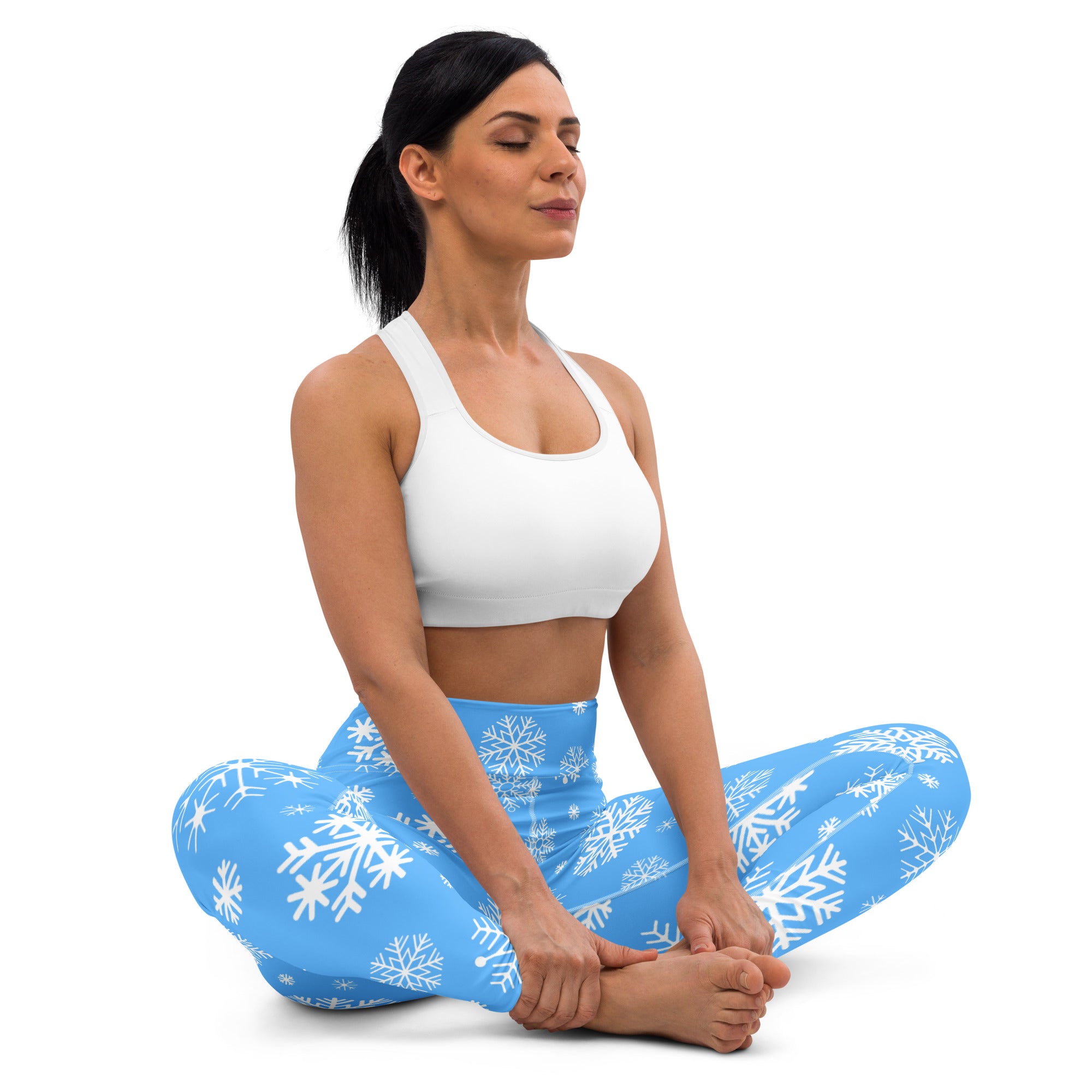 Blue buttery soft women’s yoga leggings with white snowflake pattern perfect for winter workouts