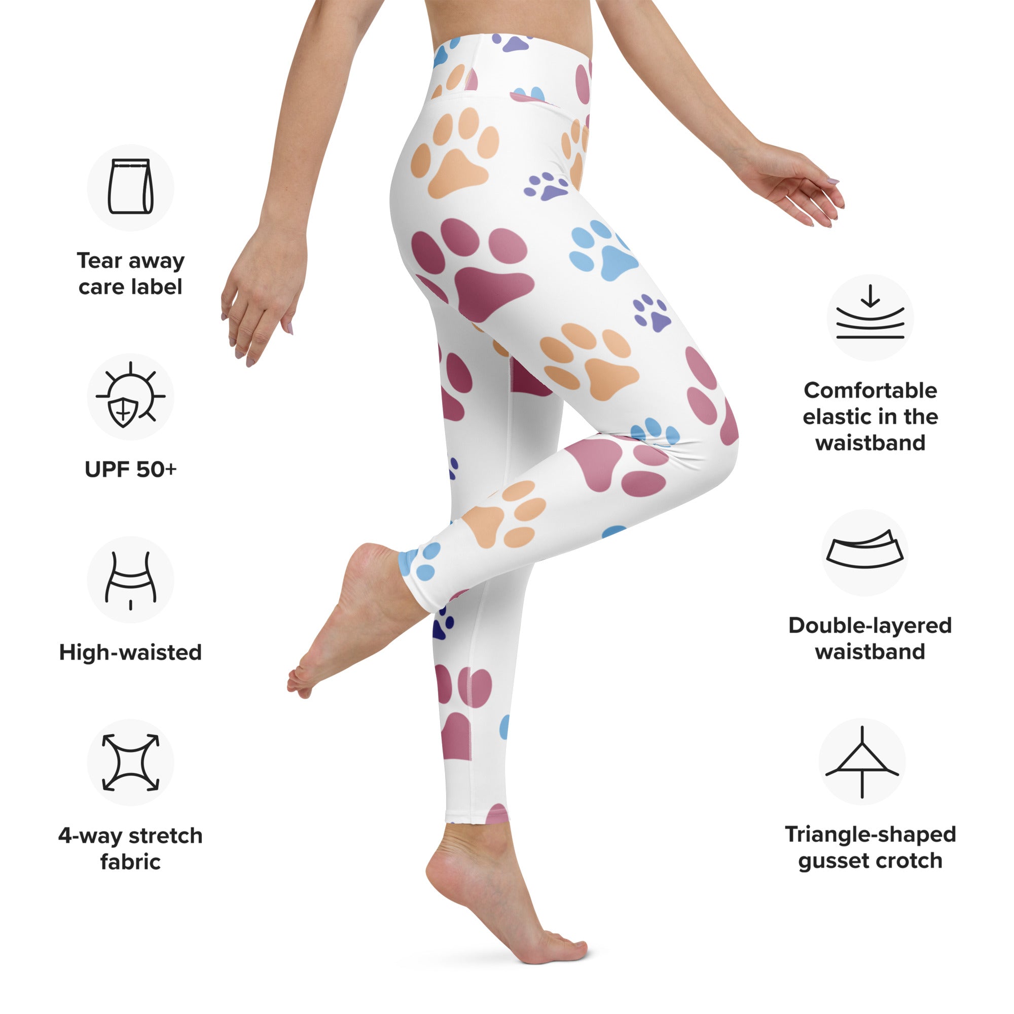White buttery soft women’s yoga leggings with colorful pink purple and blue paw print pattern