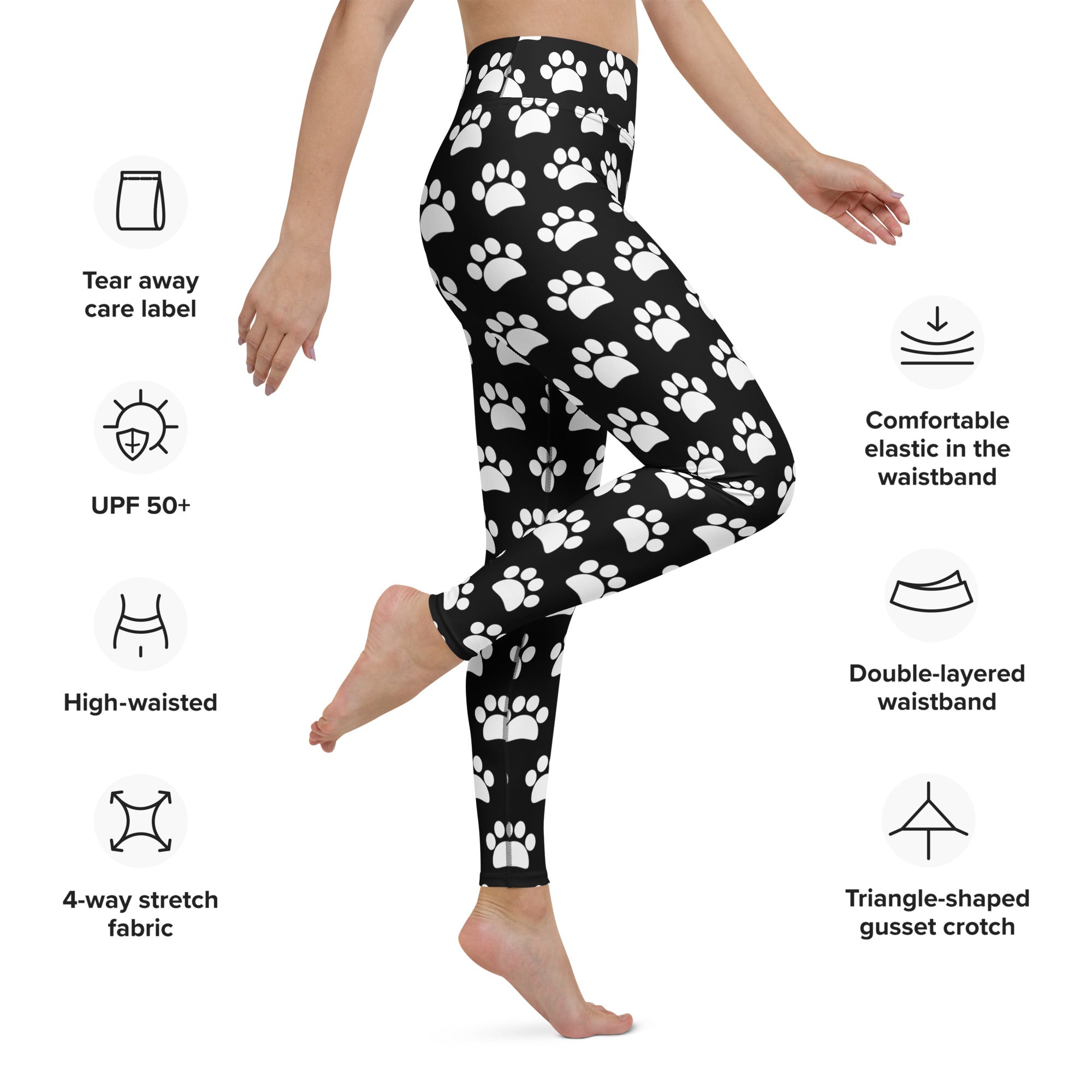 Women’s black high-waisted buttery soft yoga leggings with white paw print pattern for active wear