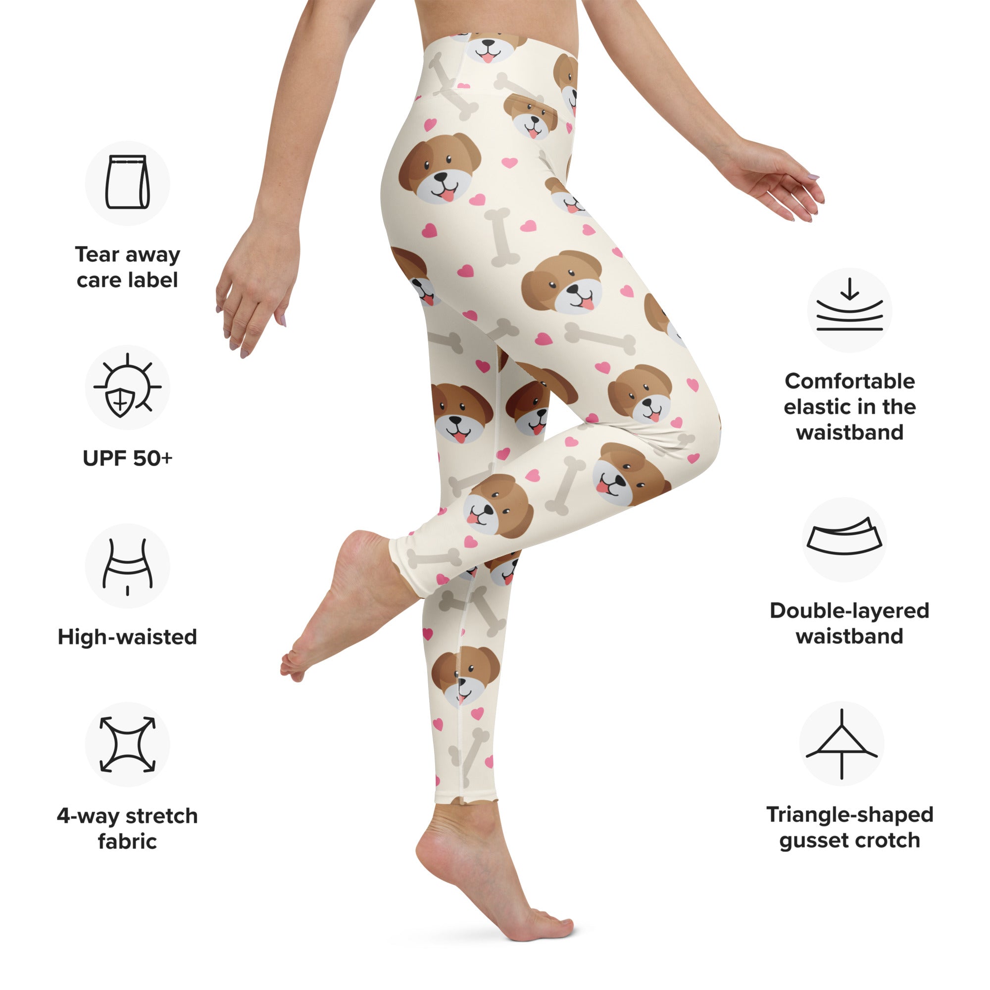 Cream-colored women’s yoga leggings with buttery soft fabric featuring brown puppy faces and pink hearts on white bones