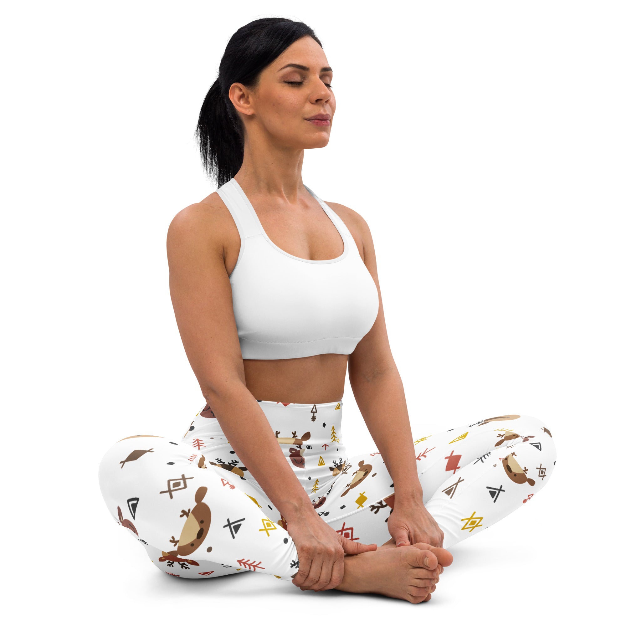 White sports bra with simple supportive design and smooth fabric paired with women’s reindeer print buttery soft yoga leggings