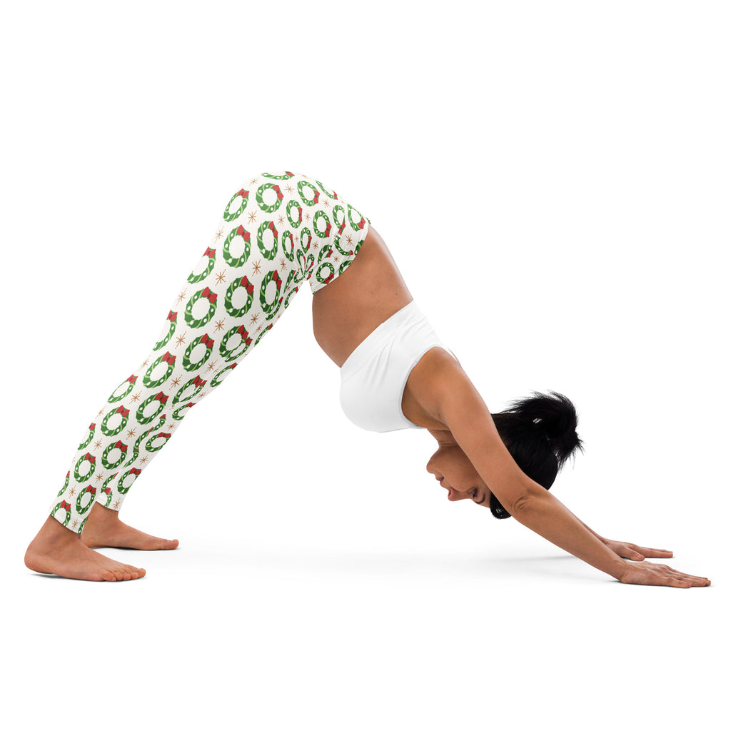Women’s white buttery soft yoga leggings with festive green wreath pattern red accents and star details