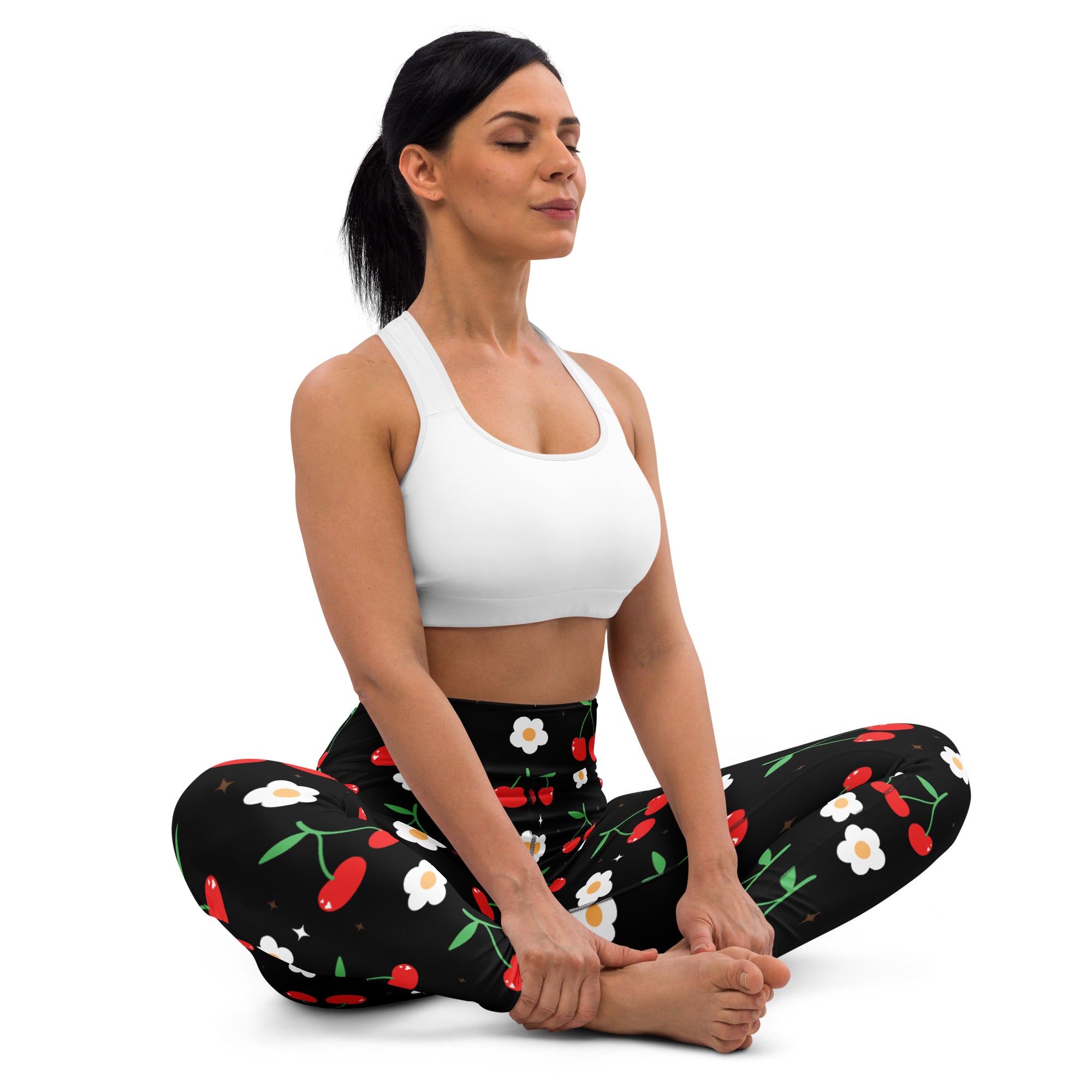 Women’s black buttery soft yoga leggings with a playful red cherry and white flower pattern with green stems