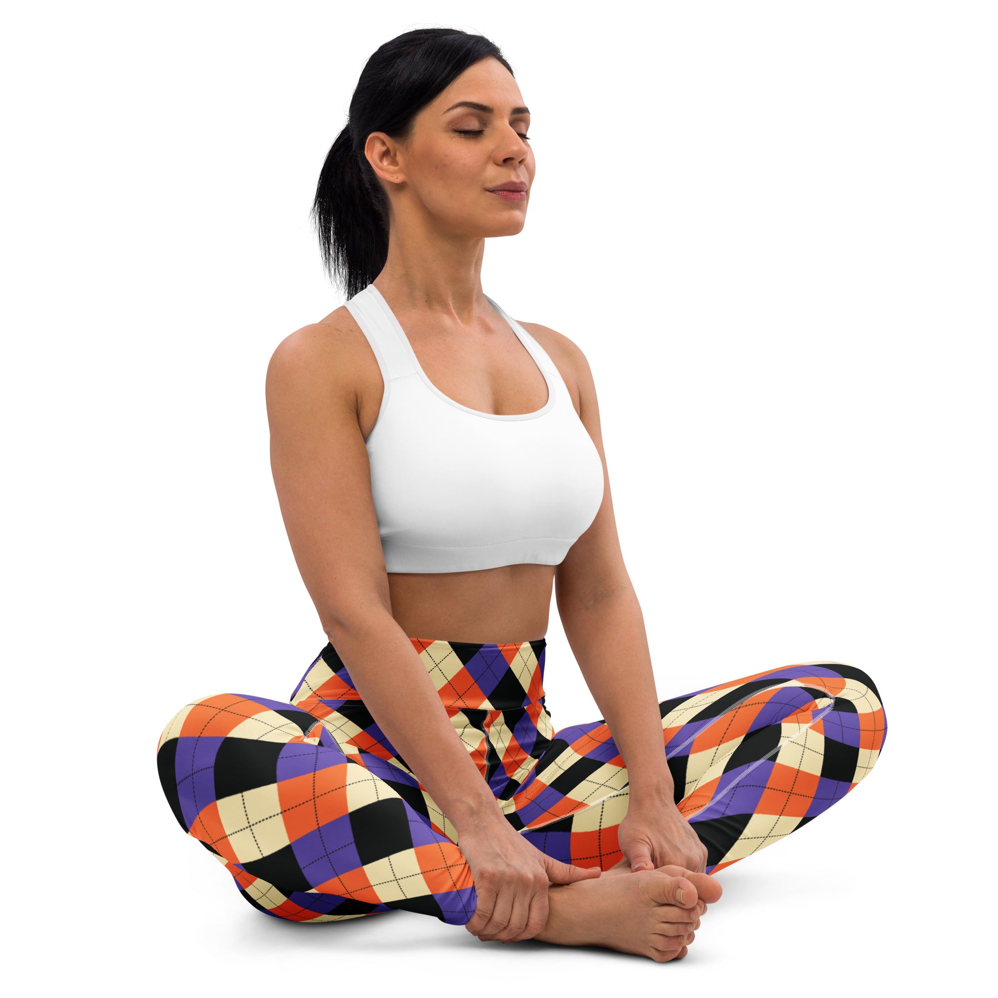 Woman wearing colorful orange purple black and cream argyle buttery soft yoga leggings for Halloween use