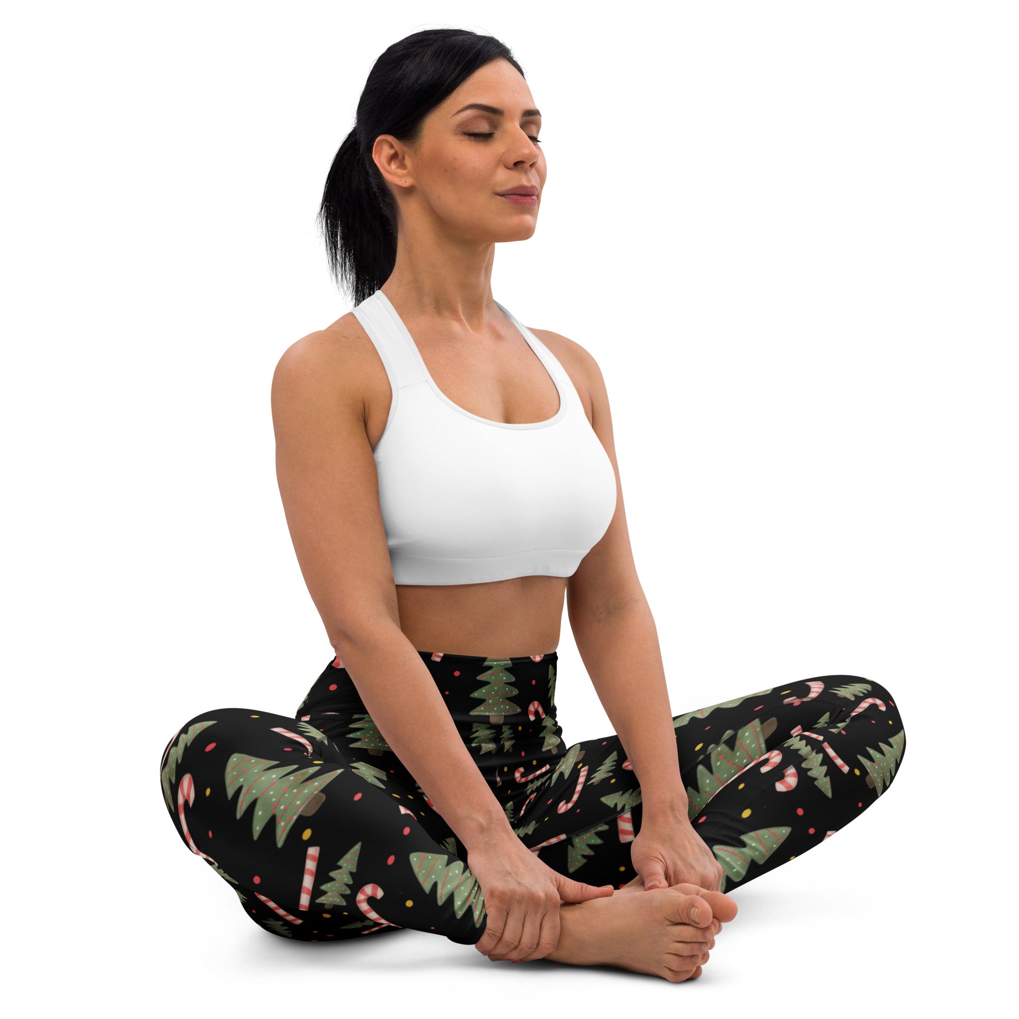 Women’s black buttery soft yoga leggings with festive green pine tree and pink candy cane pattern for Christmas