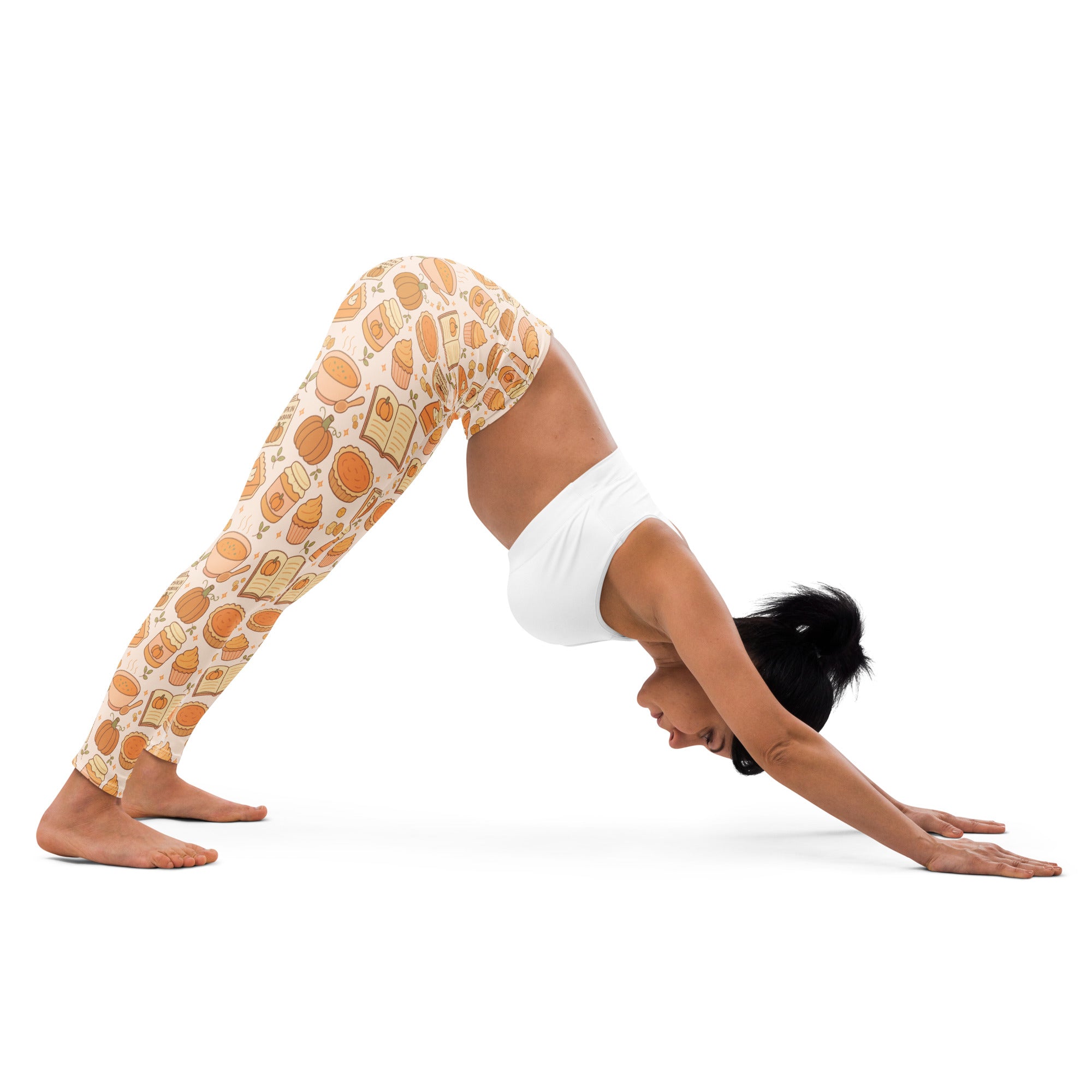Cream-colored buttery soft women’s yoga leggings with a playful pumpkin and open book pattern