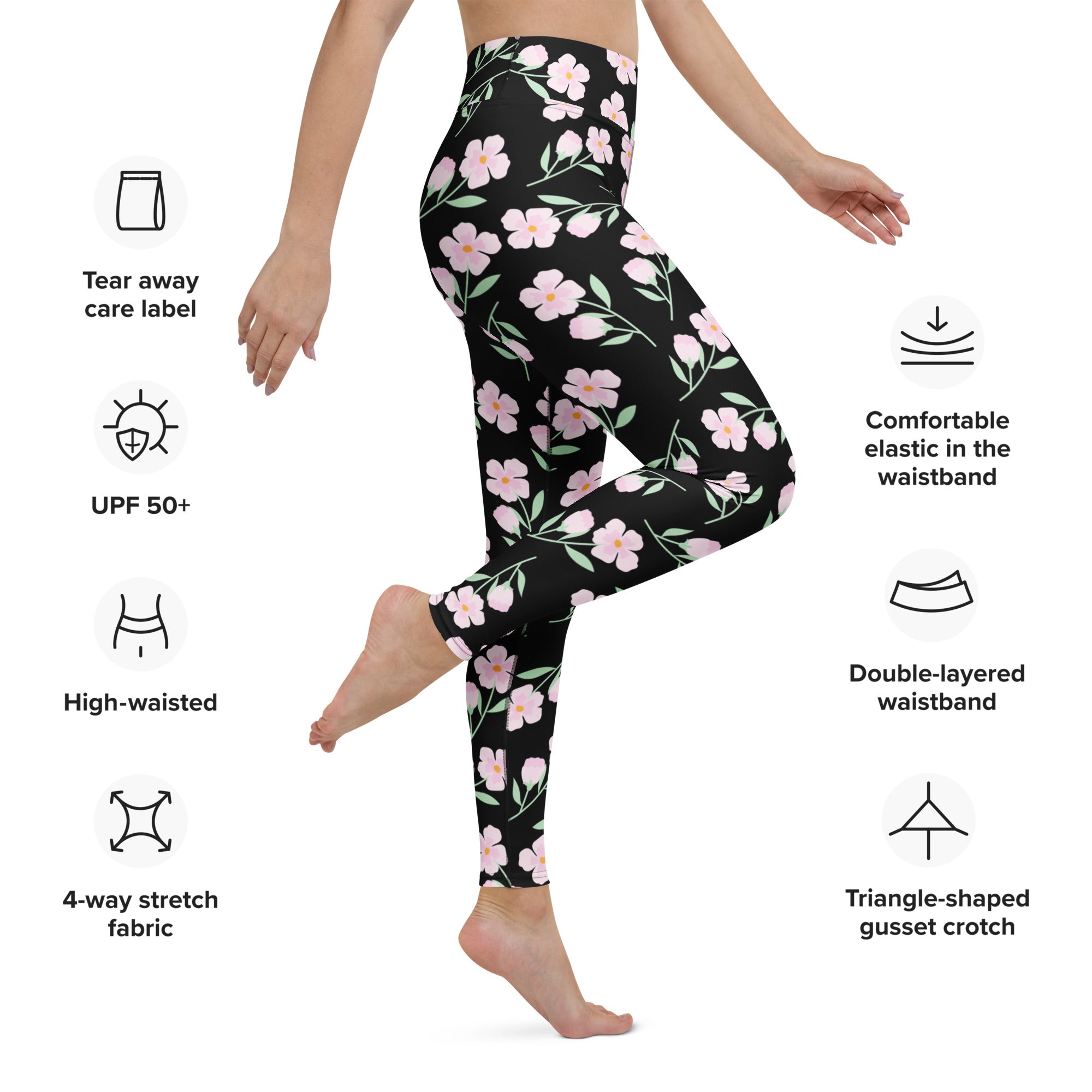 Women’s black high-waisted buttery soft yoga leggings with delicate pink floral pattern and green leaf accents