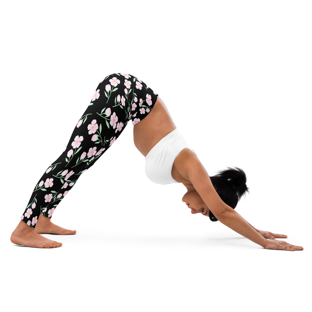 Women’s black floral buttery soft yoga leggings with delicate pink and white flower pattern on front side