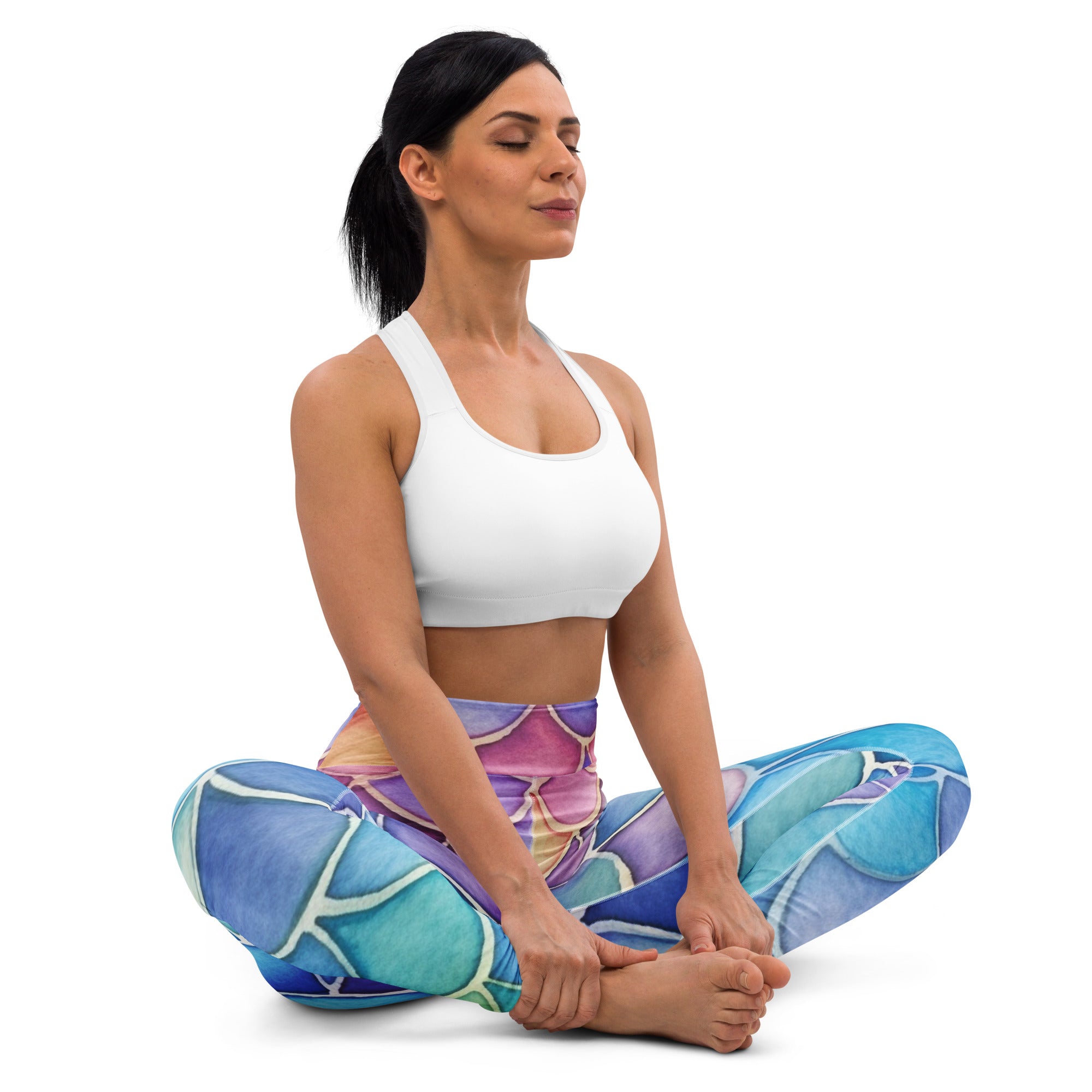 A woman wearing women’s watercolor mermaid buttery soft yoga leggings in blue purple and teal abstract pattern with a white sports bra