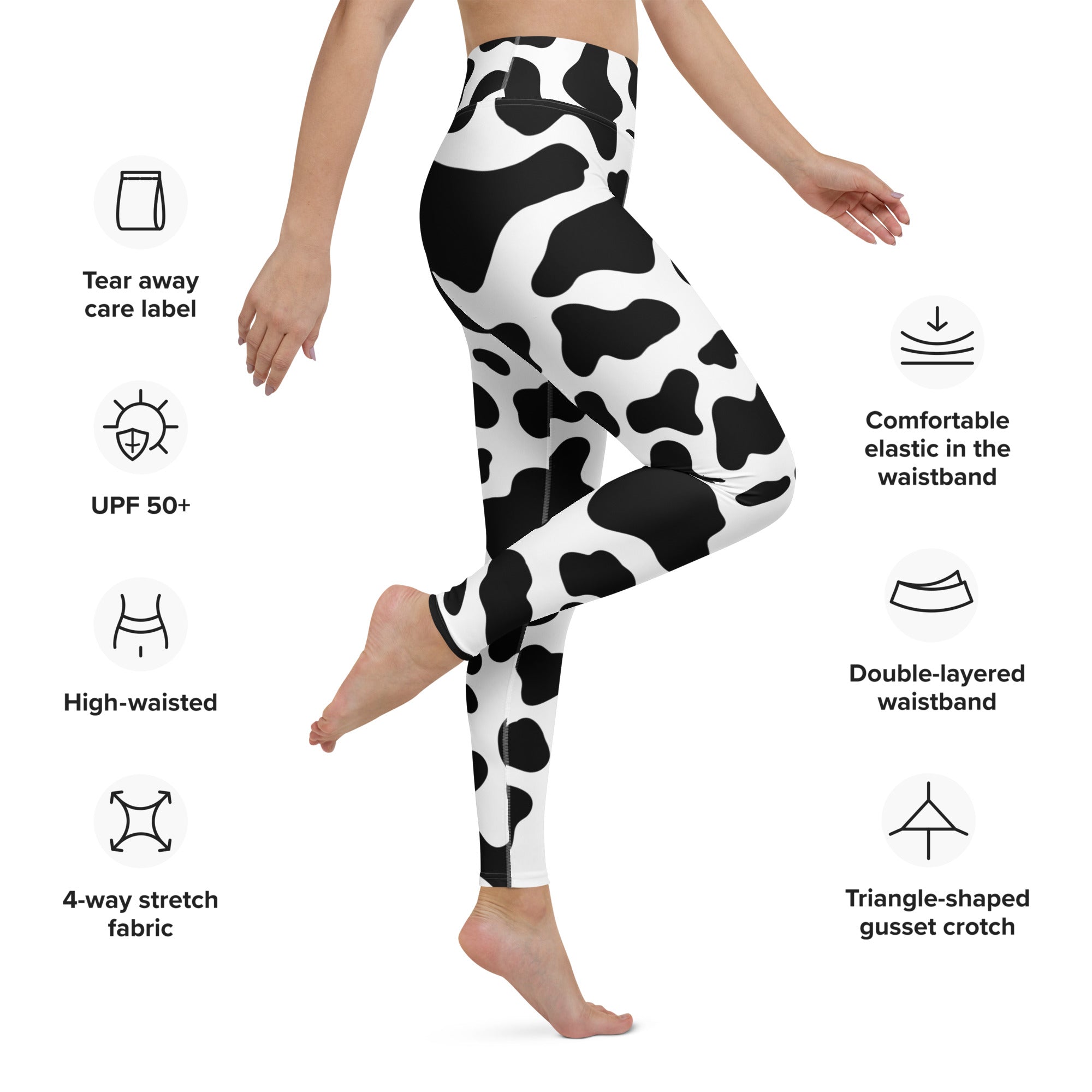 Women’s cow print buttery soft high-waisted yoga leggings in black and white 4-way stretch fabric front view