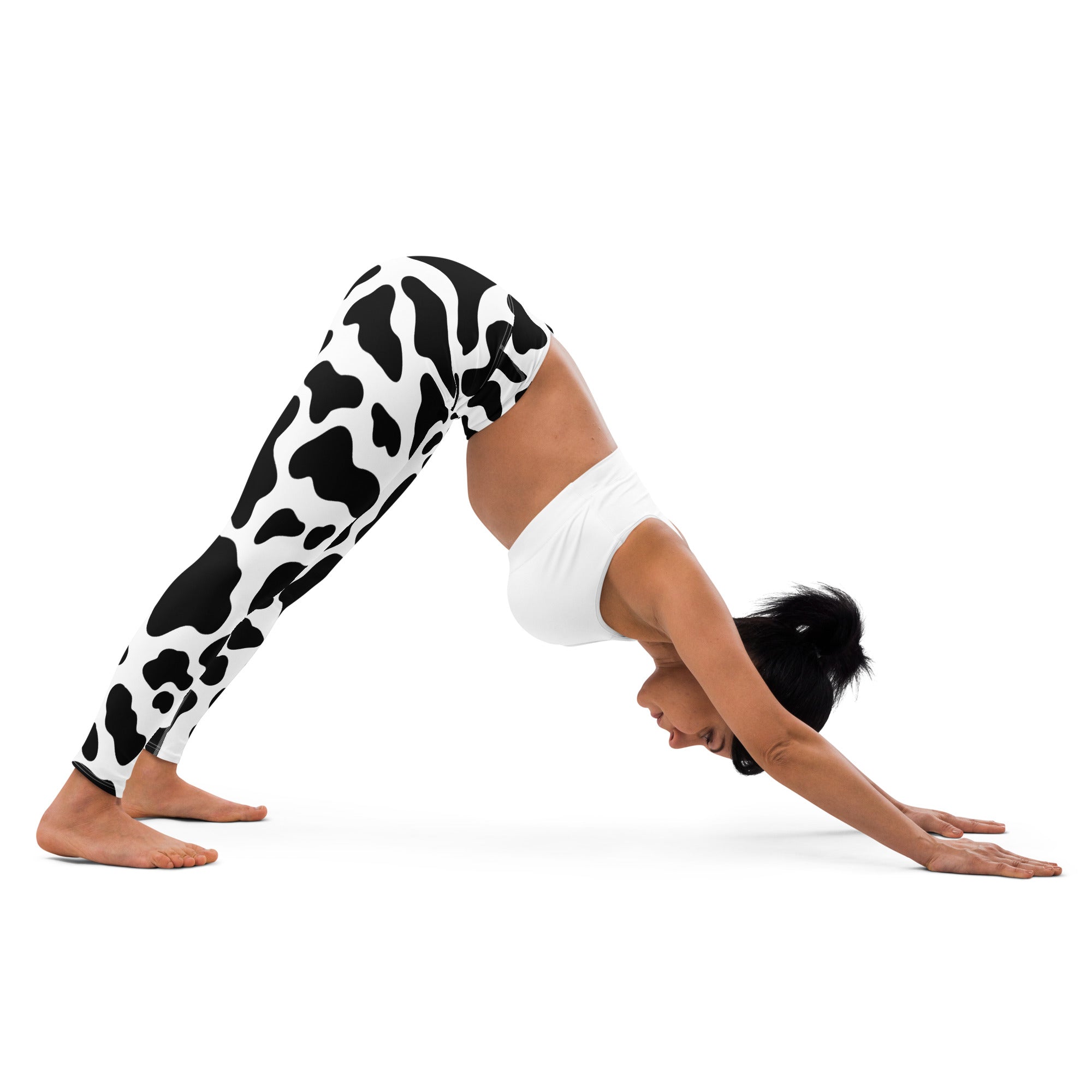 Women’s buttery soft yoga leggings in black and white cow print pattern for comfortable activewear