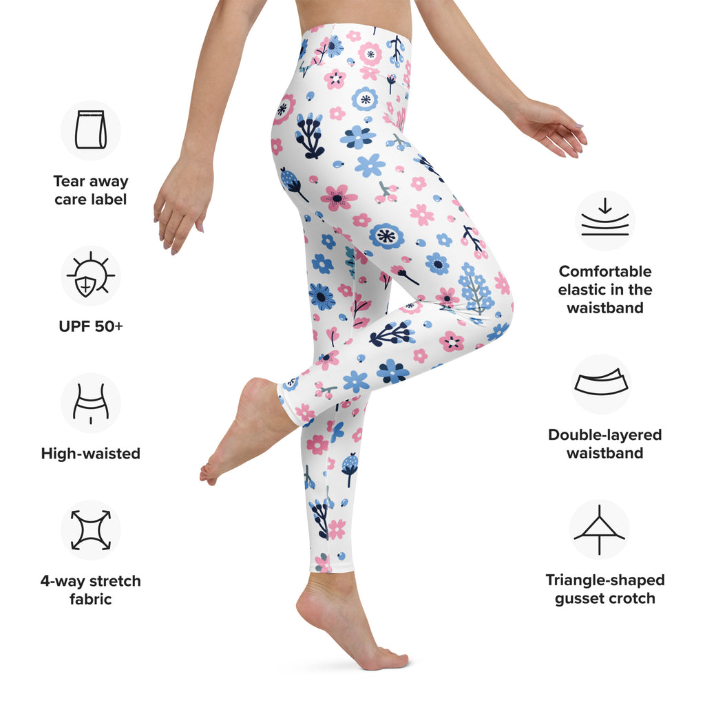 White women’s pastel floral buttery soft yoga leggings with pink and blue flowers and black stems made from stretchy fabric