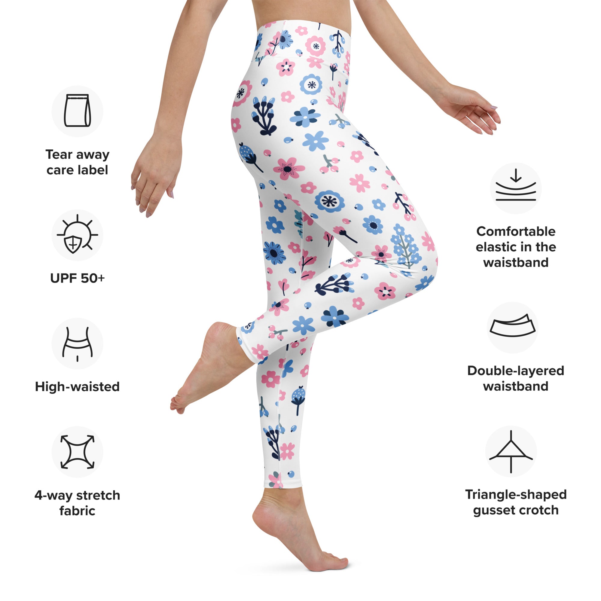 White women’s pastel floral buttery soft yoga leggings with pink and blue flowers and black stems made from stretchy fabric