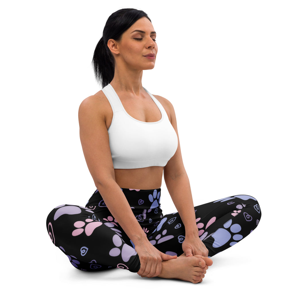 Women’s pastel paw print buttery soft yoga leggings in black with playful pink and purple paw prints