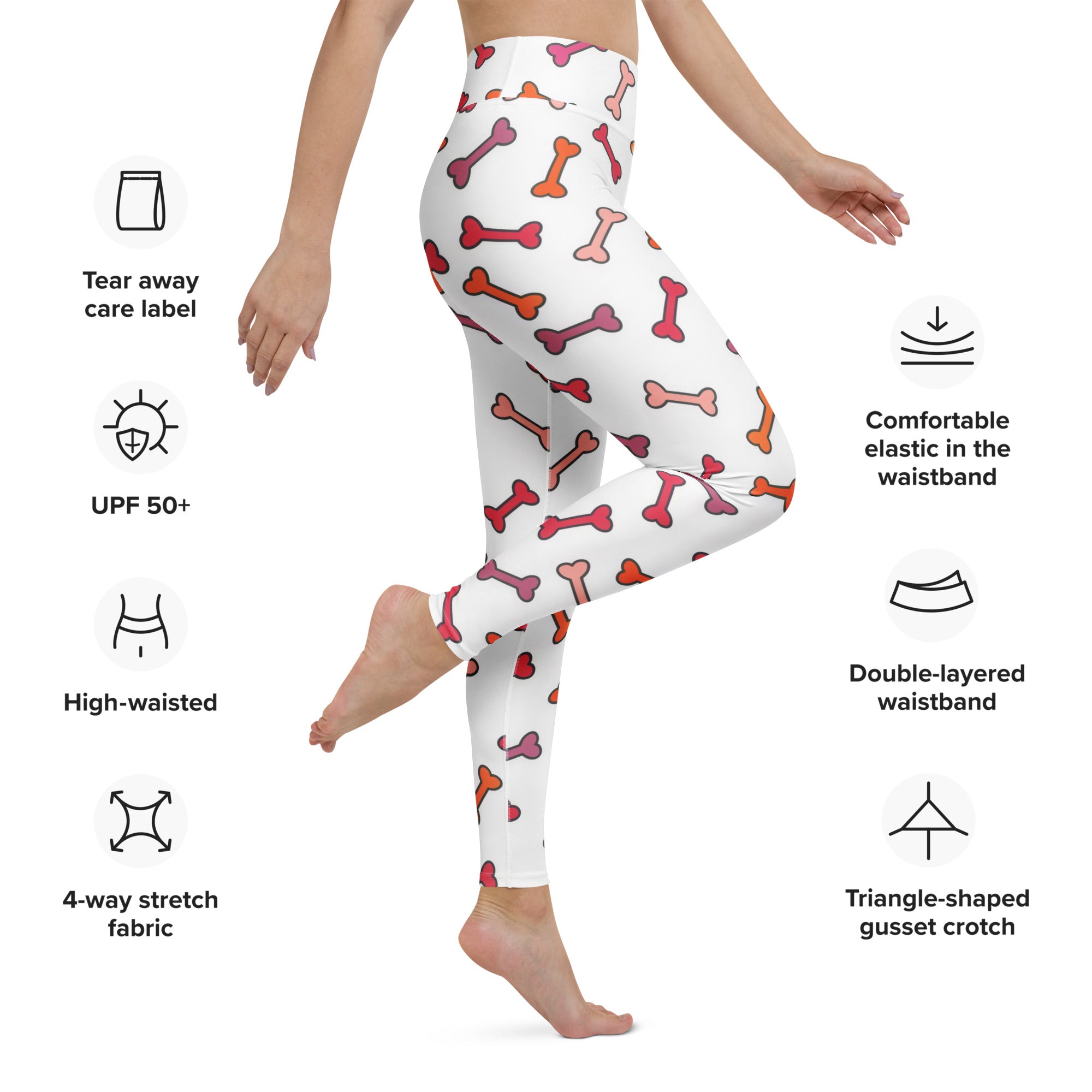 White high-waisted buttery soft yoga leggings with a playful pink and orange cartoon dog bone pattern for women