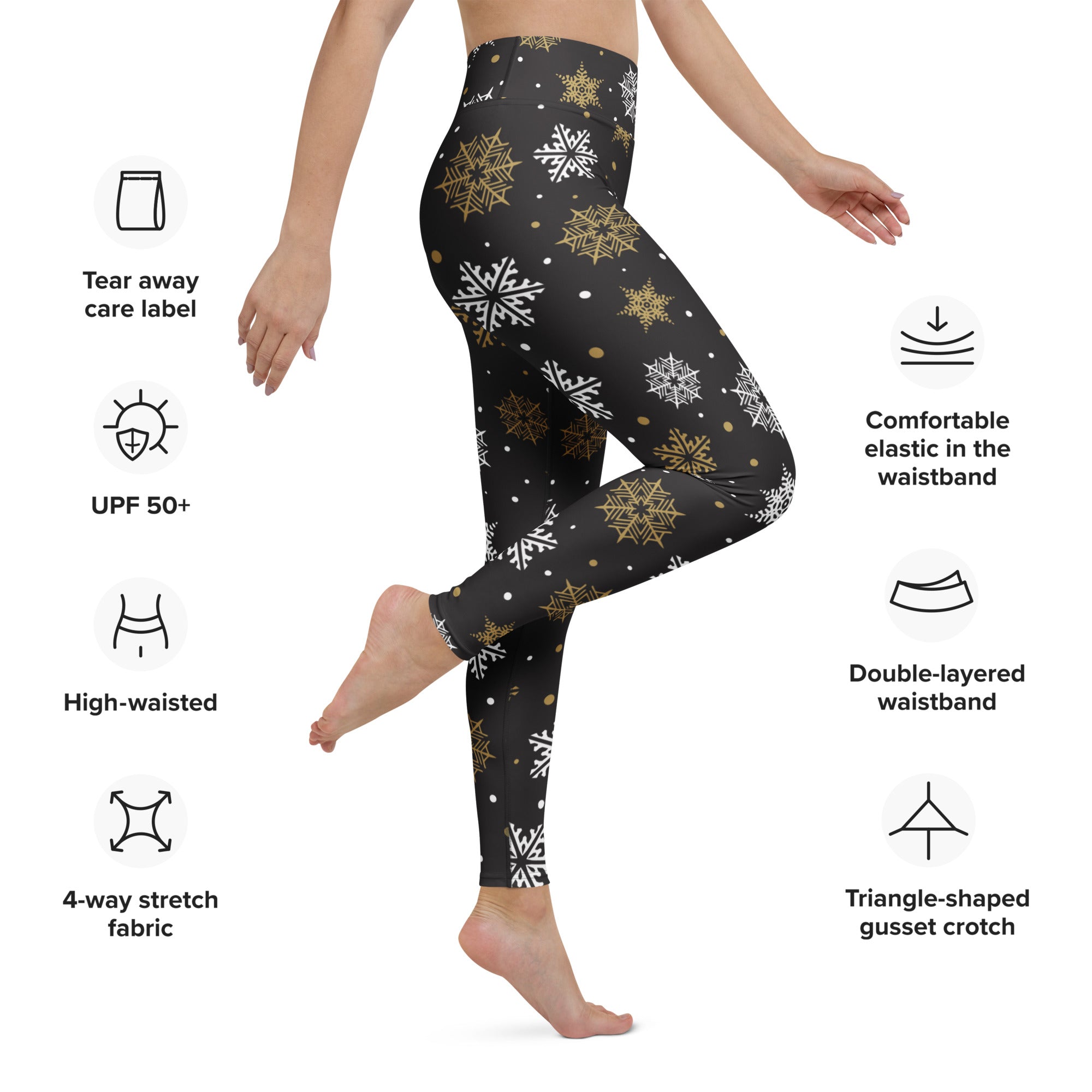 Women’s black high-waisted buttery soft yoga leggings with a festive white and gold snowflake pattern