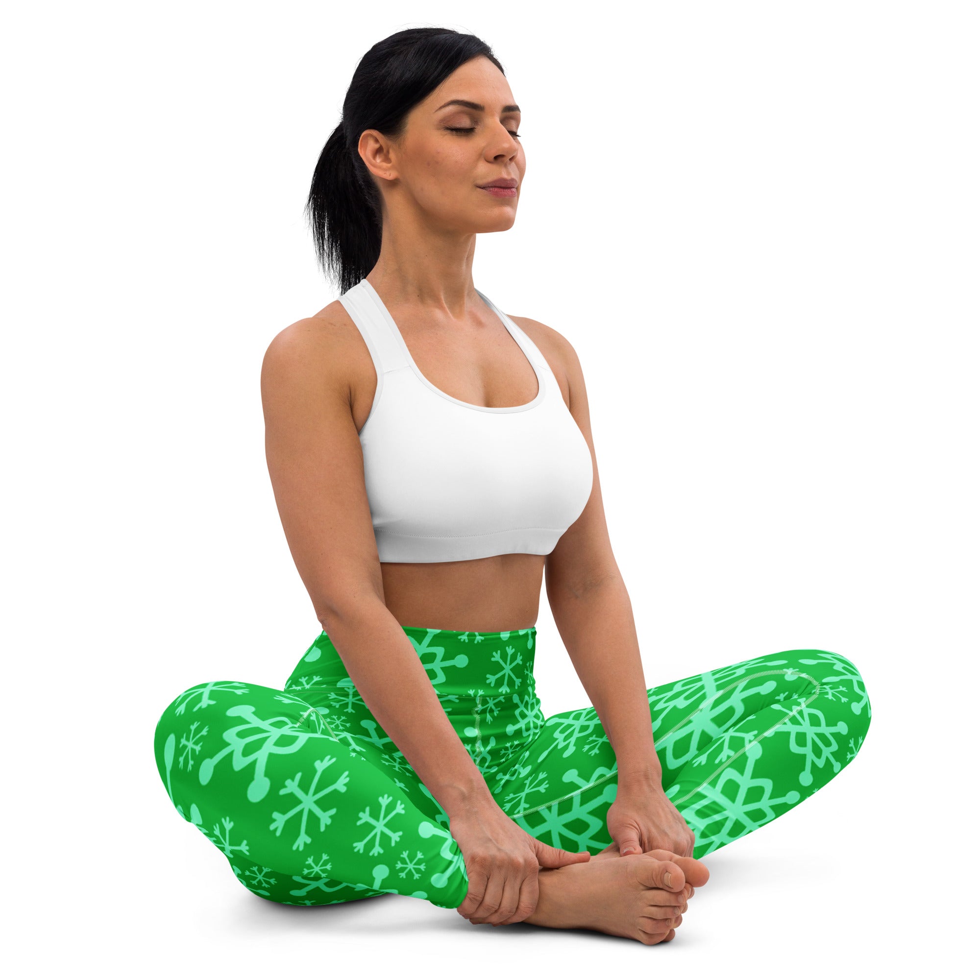 Women’s green buttery soft yoga leggings with light green snowflake pattern perfect for winter workouts