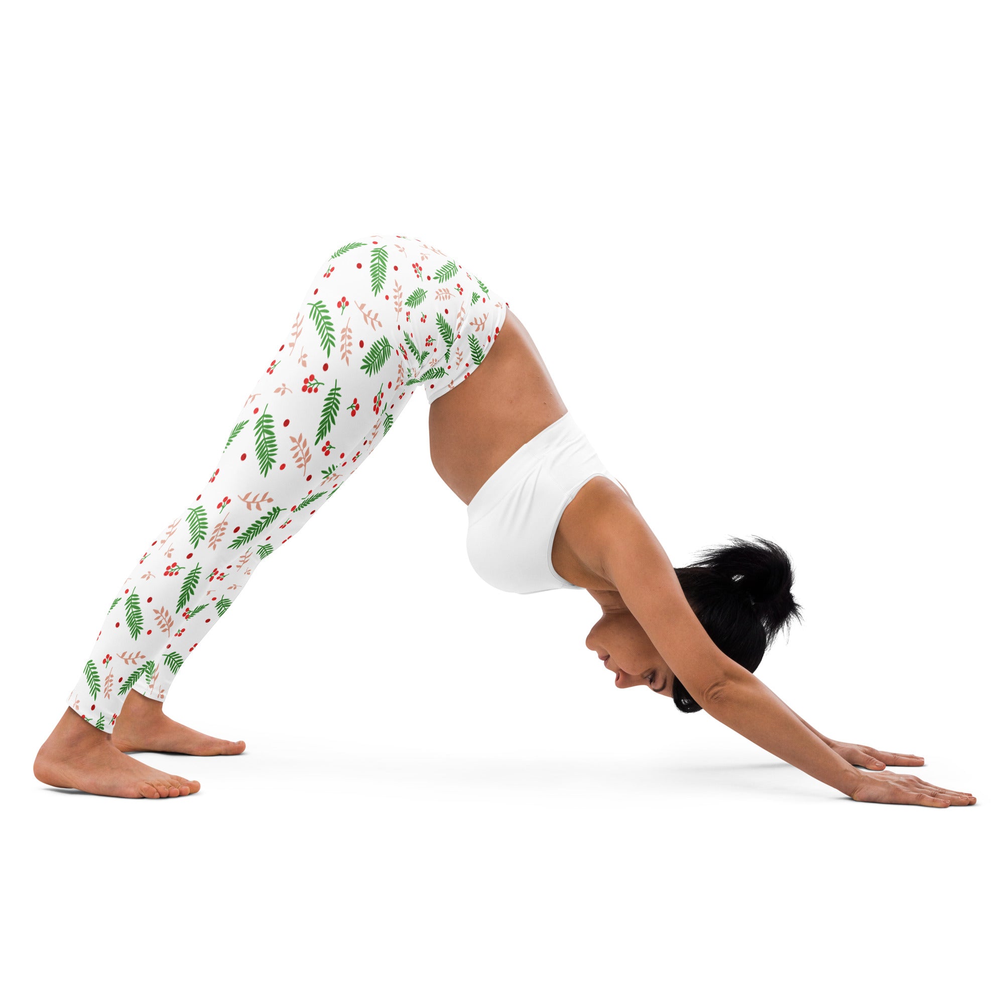 White women’s winter berry buttery soft yoga leggings with festive green fern and red berry pattern