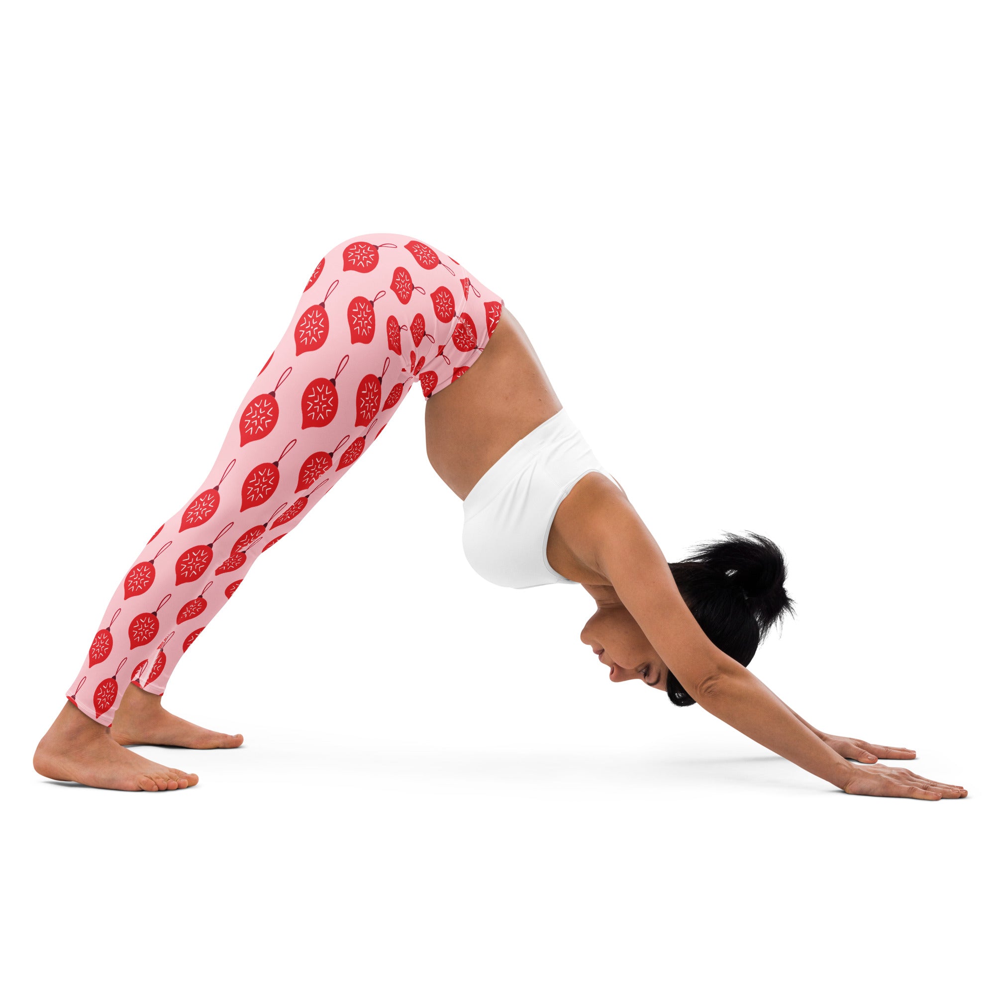 Women’s pink buttery soft yoga leggings with a repeating red Christmas ornament pattern