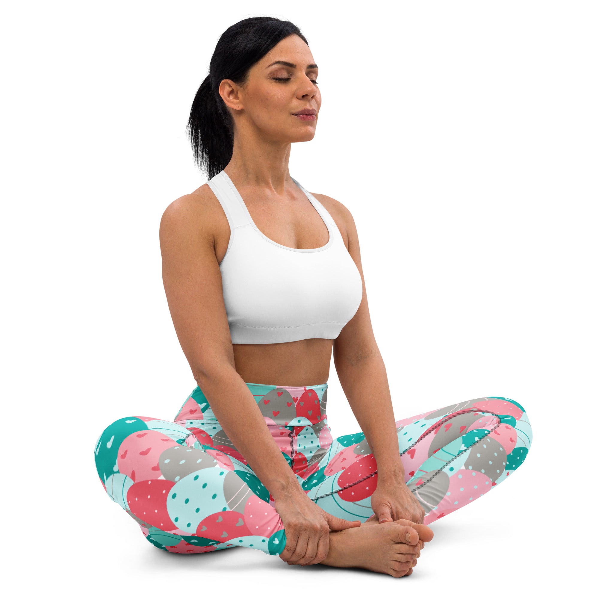 Woman wearing white sports bra and colorful pink teal polka dot buttery soft high waisted yoga leggings