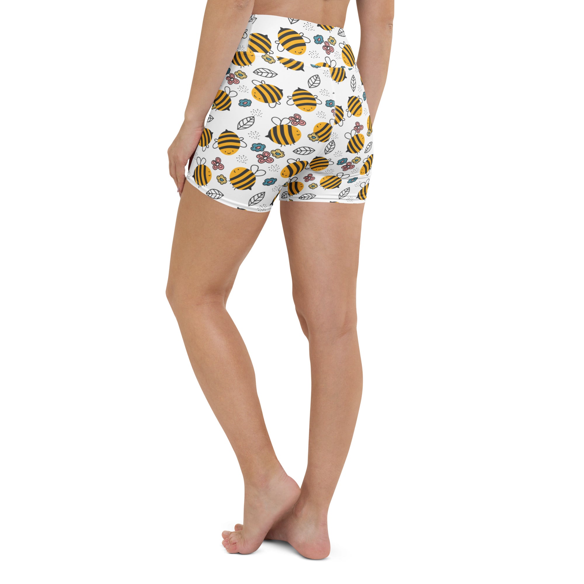 Women’s white high-waisted buttery soft yoga shorts with yellow bumblebee floral pattern and green leaves