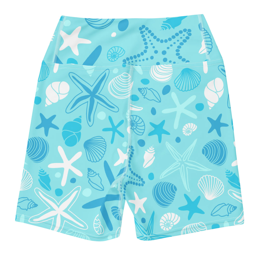 Light blue high waisted buttery soft women’s yoga shorts with white and dark blue starfish and shell patterns
