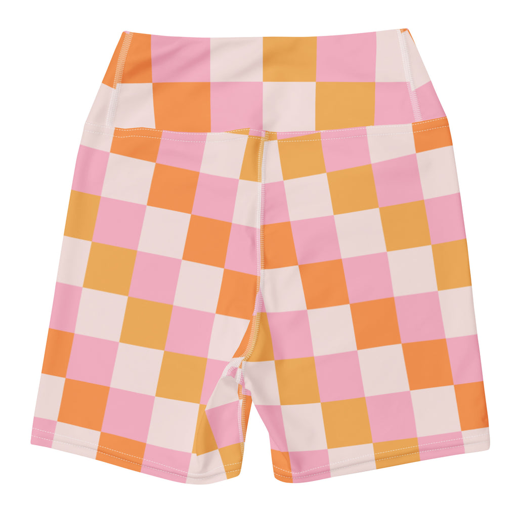 Women’s high-waisted buttery soft yoga shorts with vibrant pink and orange checkered pattern and white accents