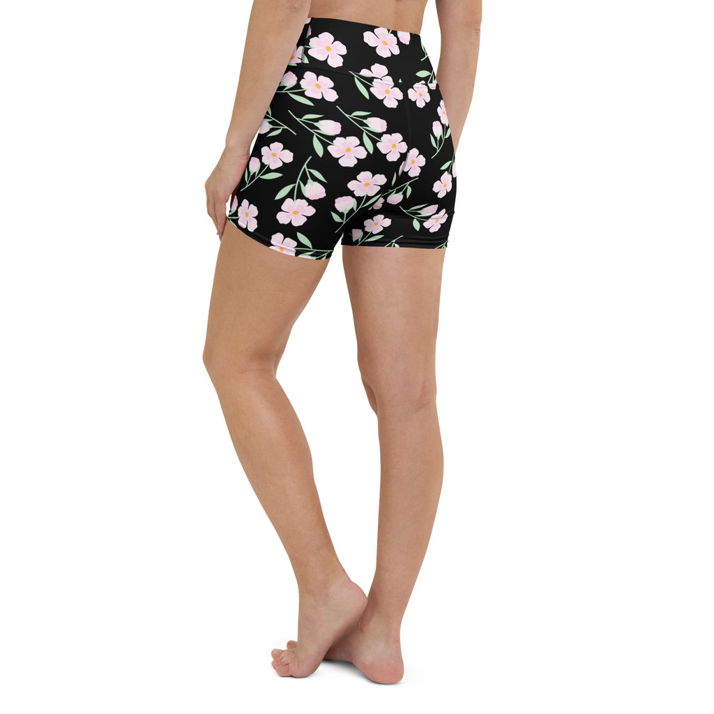 Women’s black high waisted floral yoga shorts with pink flowers and green stems in buttery soft fabric