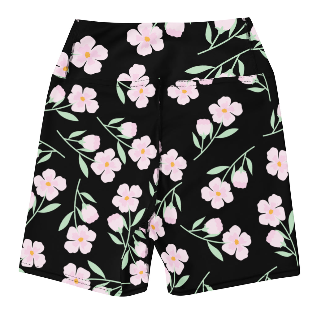 Women’s high waisted black floral yoga shorts with vibrant pink and yellow flower pattern and buttery soft fabric