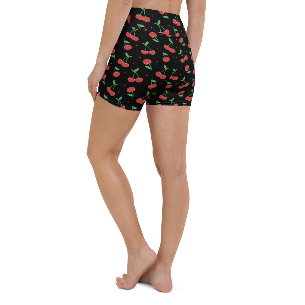 Women’s black high waisted buttery soft yoga shorts with vibrant red cherry pattern and green stems
