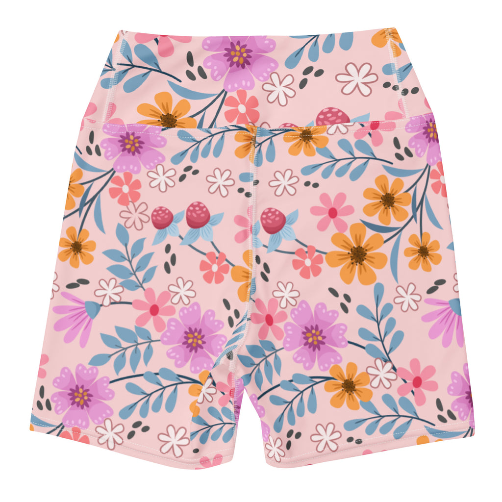 Women’s pink floral yoga shorts with high waisted design featuring purple orange white flowers and blue leaves on soft fabric