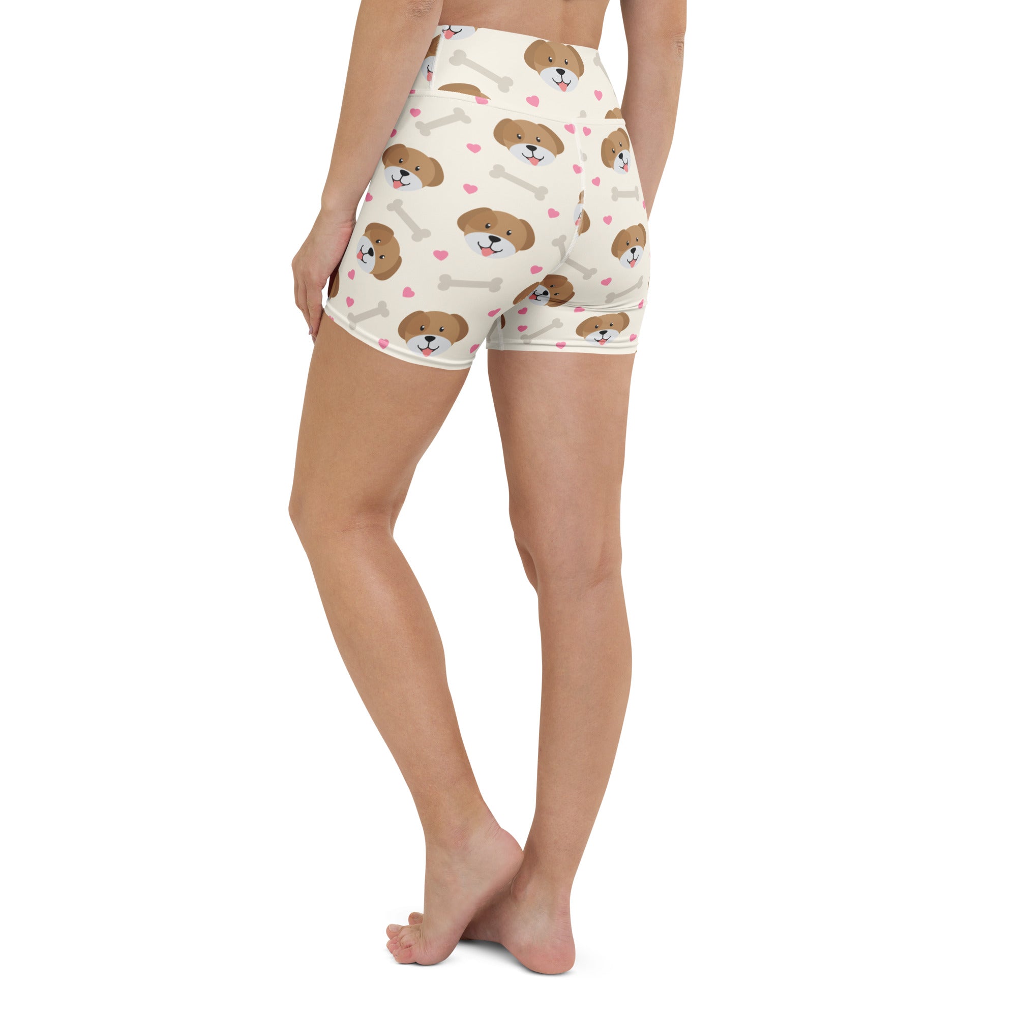 Cream-colored high waisted buttery soft yoga shorts with brown puppy faces white bones and pink hearts print