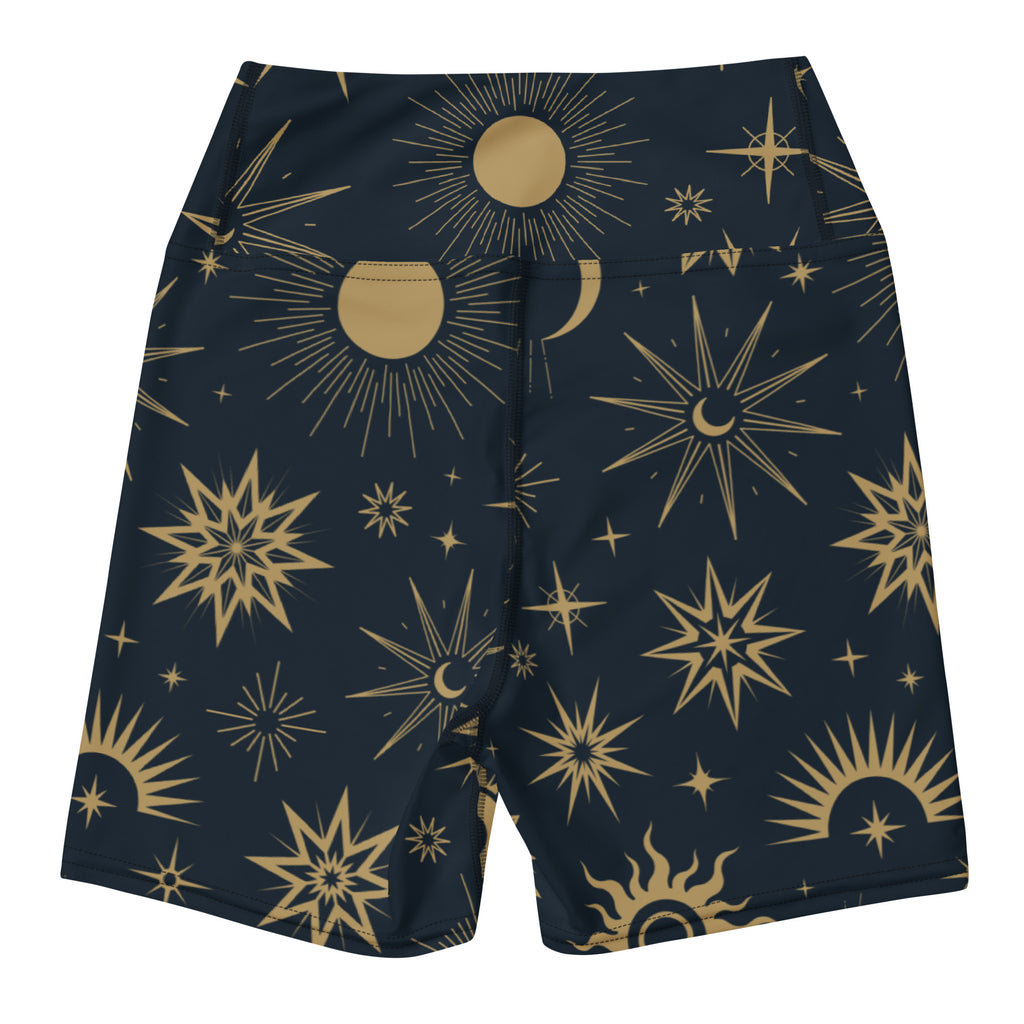 Women’s dark blue high waisted buttery soft yoga shorts with a vibrant gold celestial sun moon and star pattern