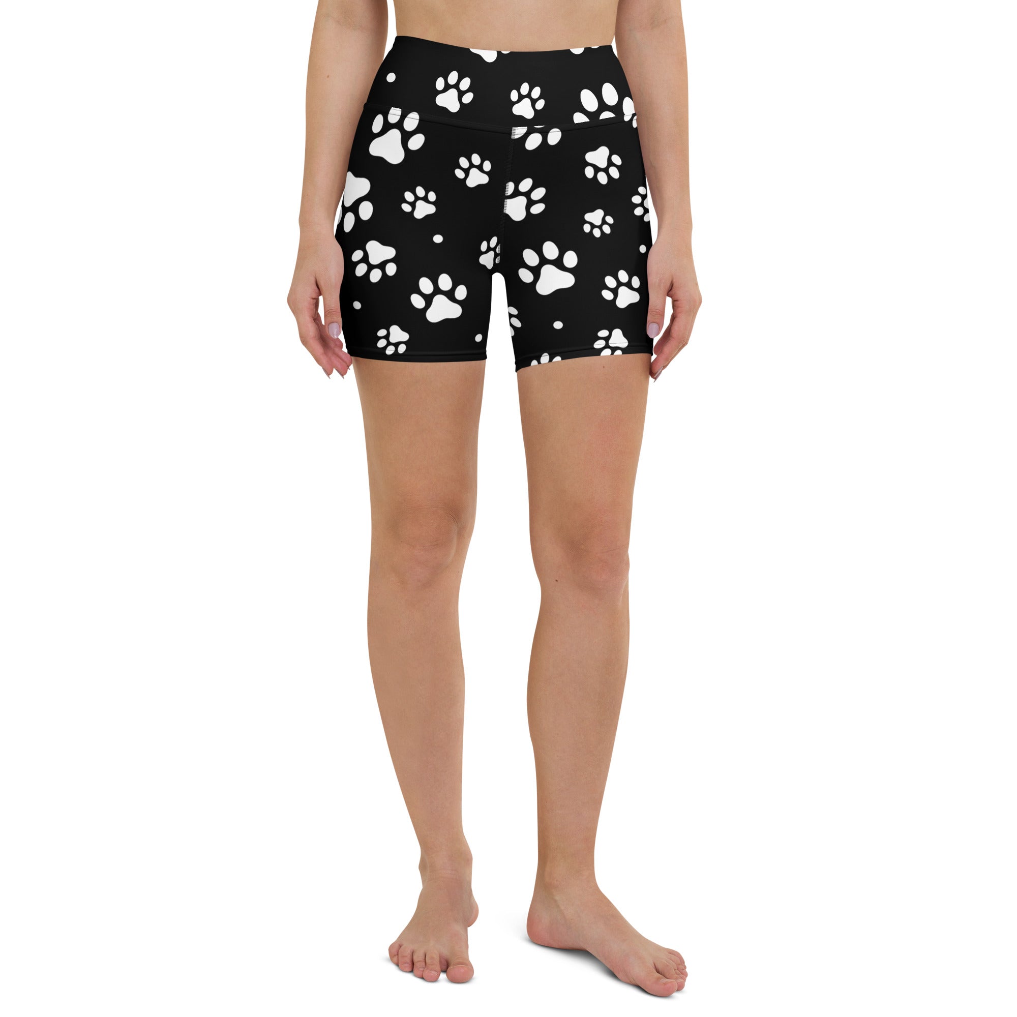 Black high waisted buttery soft women’s yoga shorts with white paw print pattern for active wear