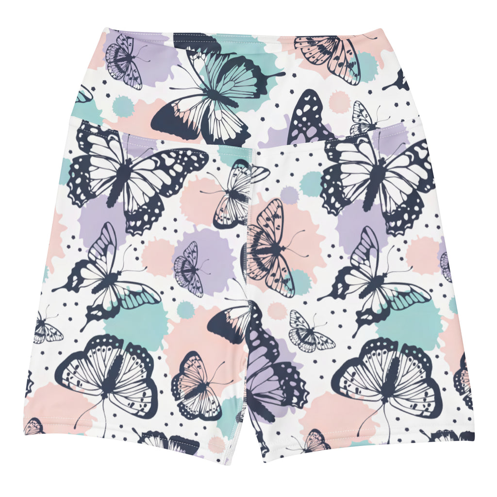Women’s butterfly yoga shorts in buttery soft fabric with vibrant black and teal butterfly pattern on pastel splotches