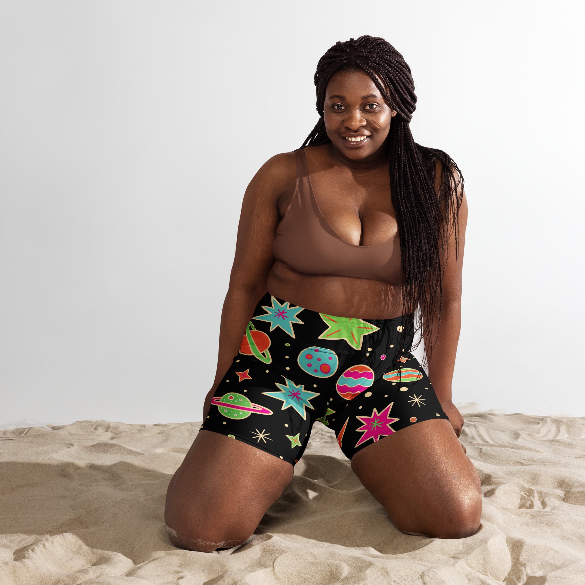 Women’s retro space yoga shorts in black featuring a vibrant space-themed pattern on buttery soft fabric