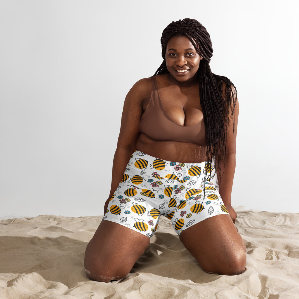 Women’s high waisted buttery soft white yoga shorts with yellow and black bumblebee floral pattern