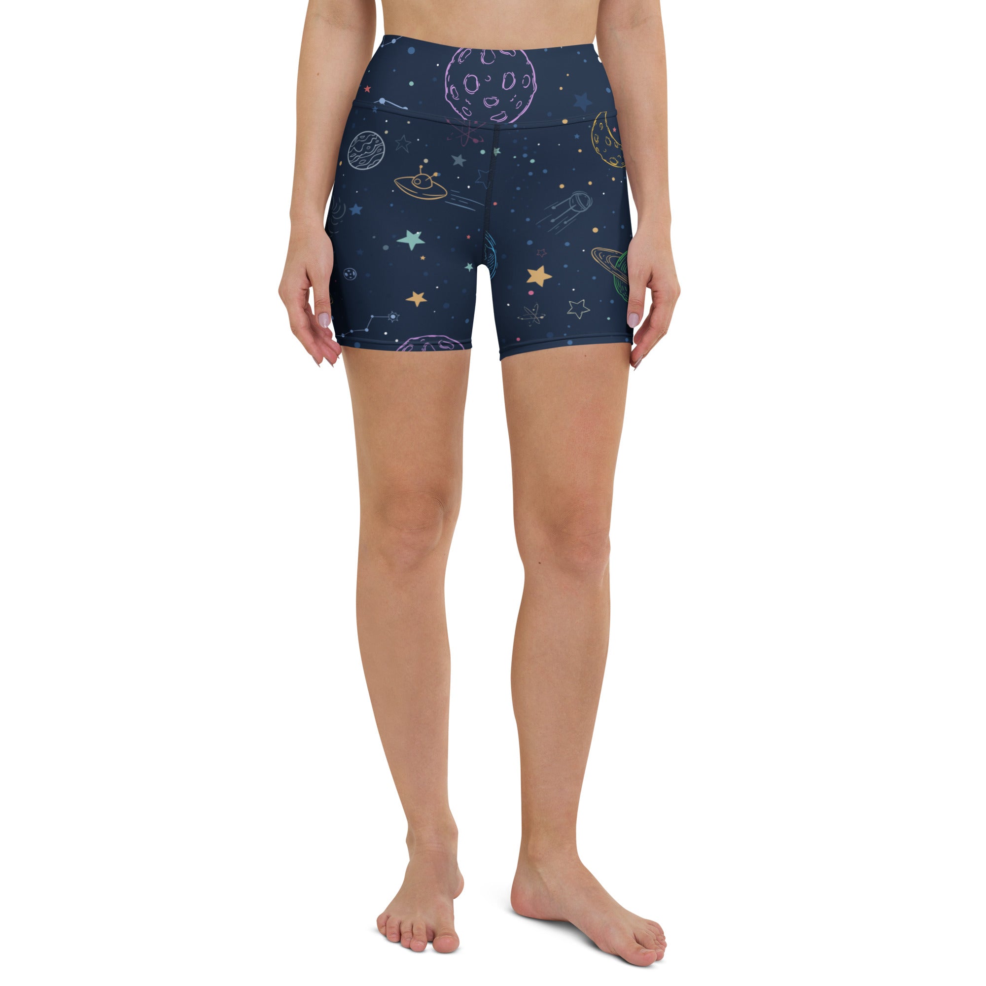 Dark blue high waisted buttery soft women’s yoga shorts with whimsical pastel space themed planets stars and ufos print