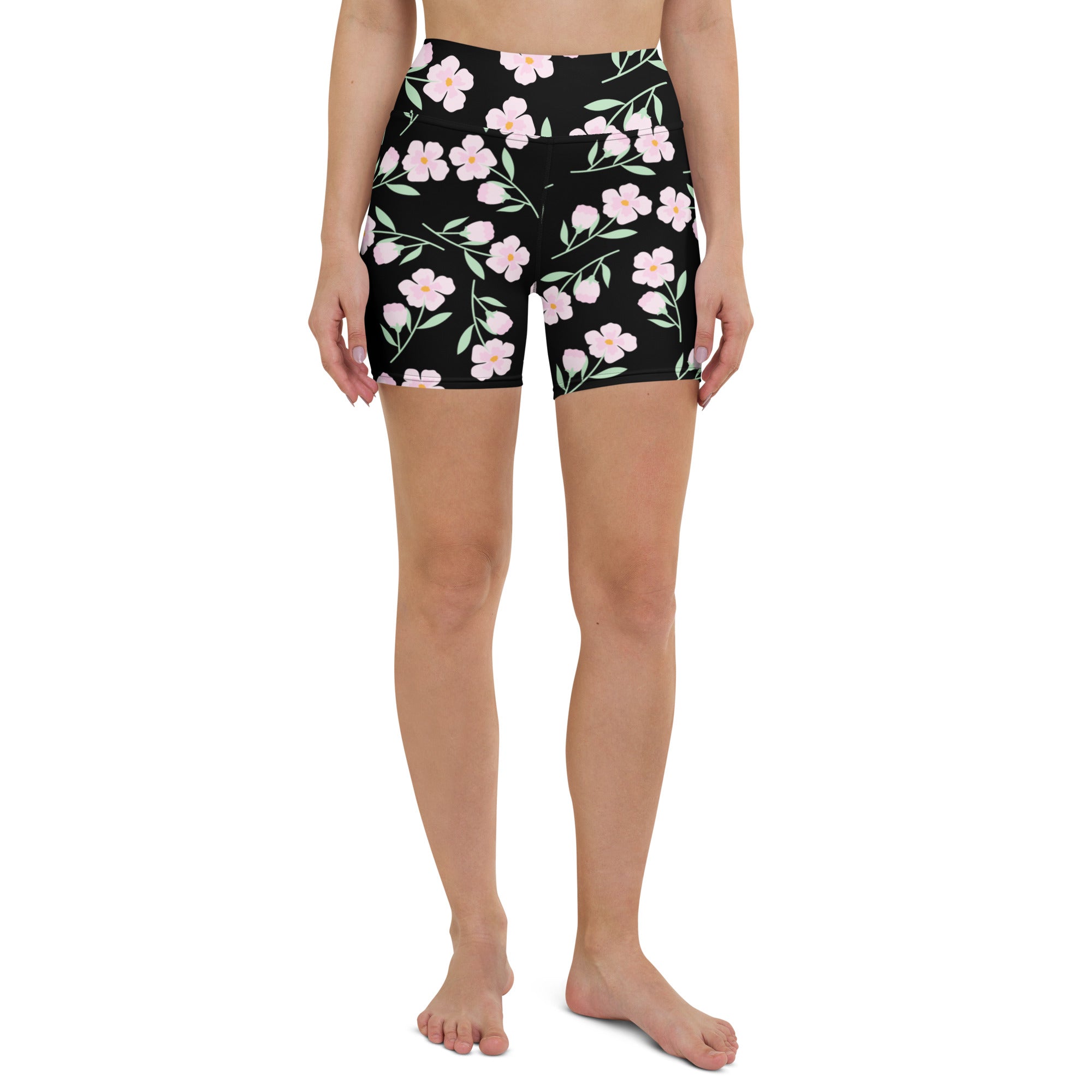 Women’s black high waisted buttery soft yoga shorts with pink floral pattern and green stems for activewear