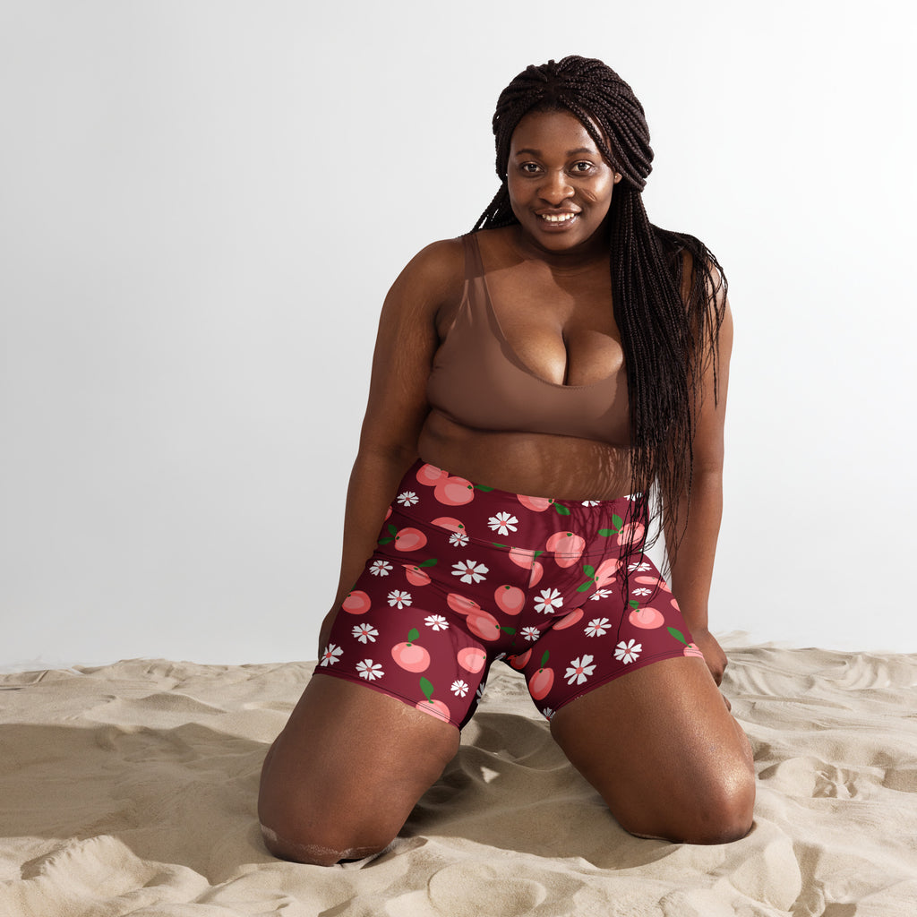Women’s high waisted buttery soft maroon yoga shorts with playful pink peach and white daisy floral pattern