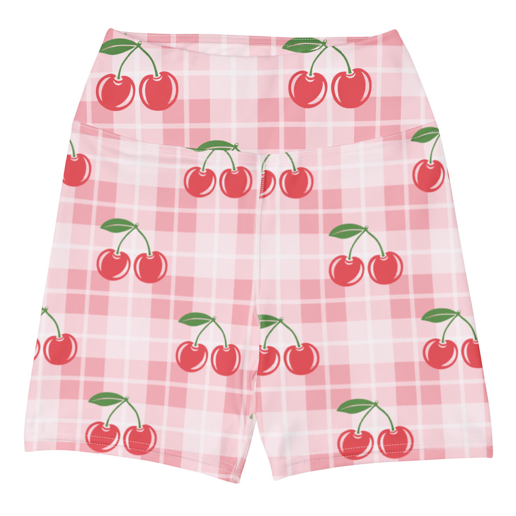 Women’s pink gingham cherry high-waisted yoga shorts in buttery soft fabric displayed on a plaid background