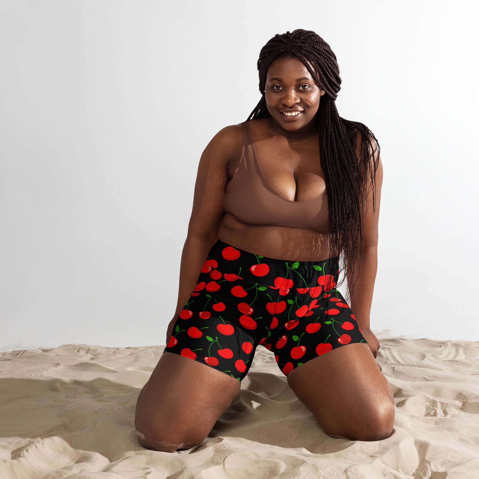 Women’s high waisted buttery soft black yoga shorts with vibrant red cherry pattern and green stems and leaves