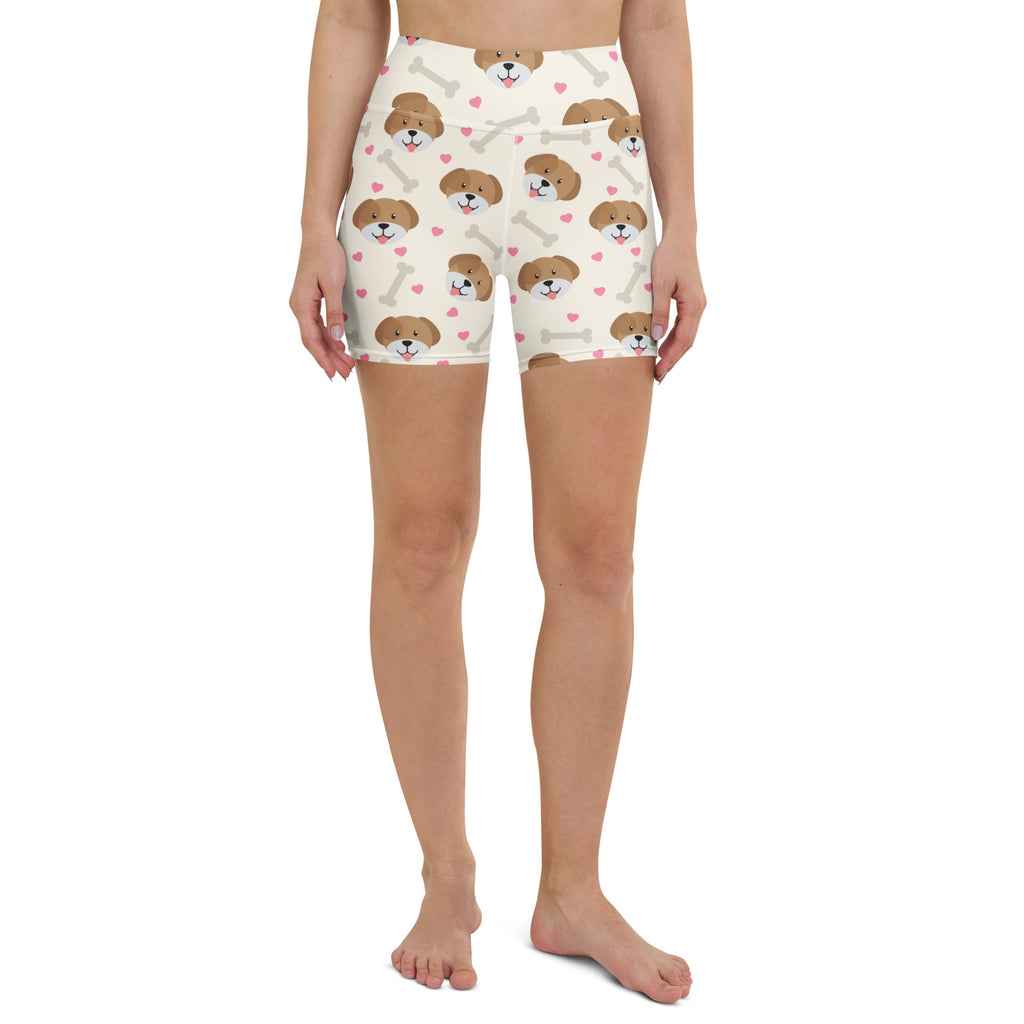 Cream-colored high-waisted buttery soft yoga shorts with cute brown puppy faces pink hearts and white bones print